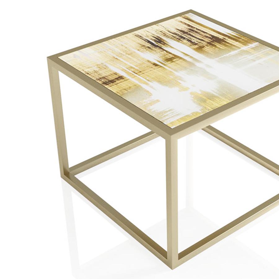 Coffee table gilding medium with top in decorated glass made
with hand-painted gold leaf with an anitique mirrored finish.
With steel tube-shaped base stained with gold satinated finish.
 