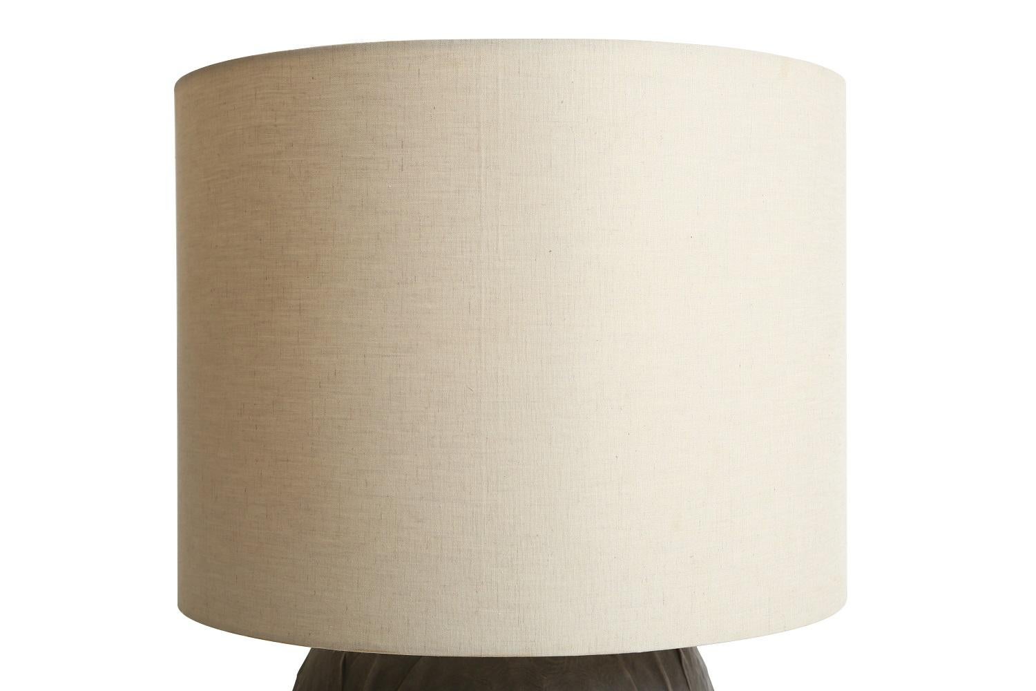 Turtle molded ceramic round table lamp base with cotton chambray shade, made in Paris by Giles Caffier.

Dimensions:

Base: 11