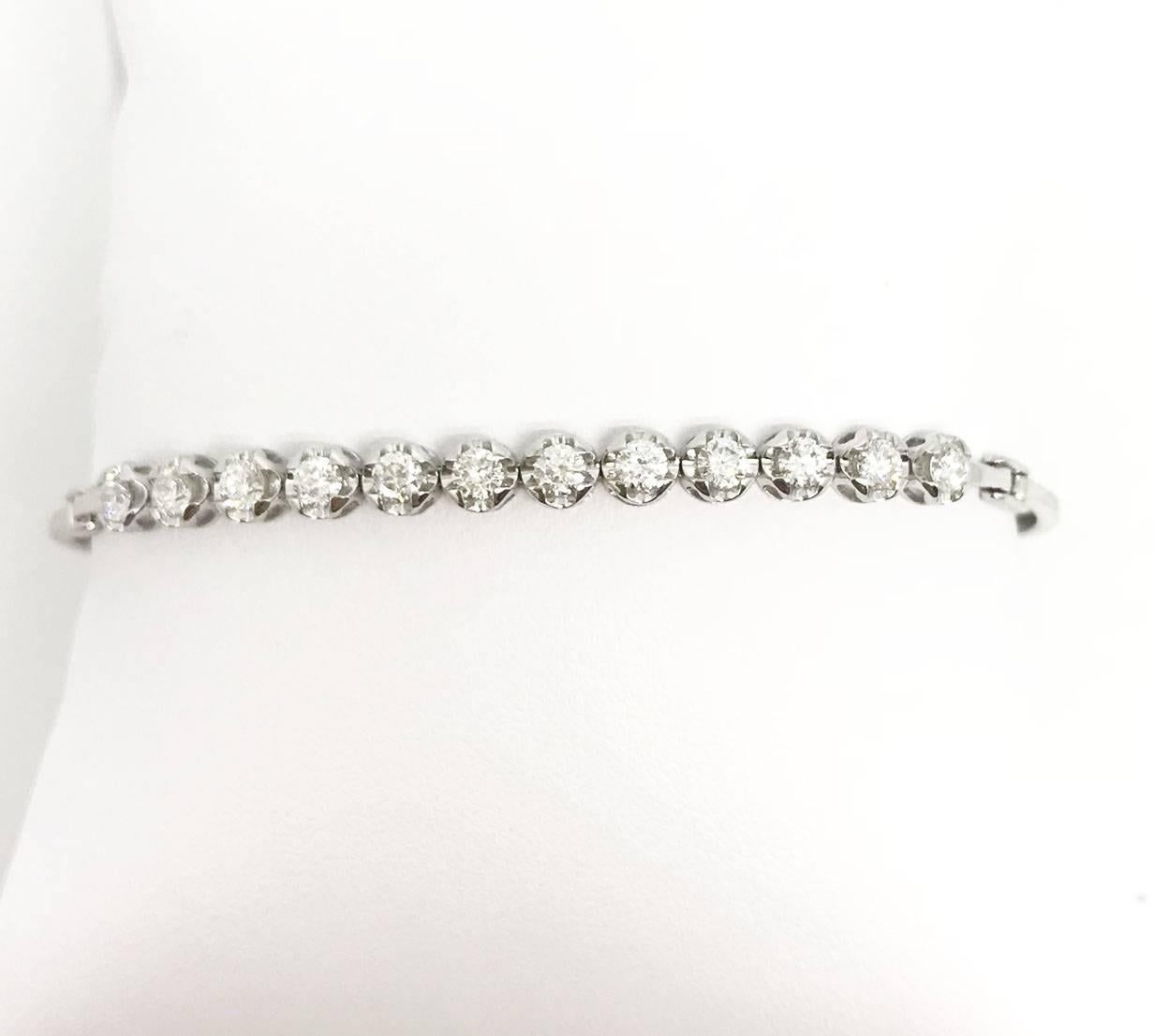 Running out of anniversary gift ideas? This 1/3 way diamond tennis bangle bracelet is definitely your bestest choice. The diamond all together weighing 1.31 Carat and the bracelet is 5.5 inches long, setting in 18K White Gold. There is a tail at the
