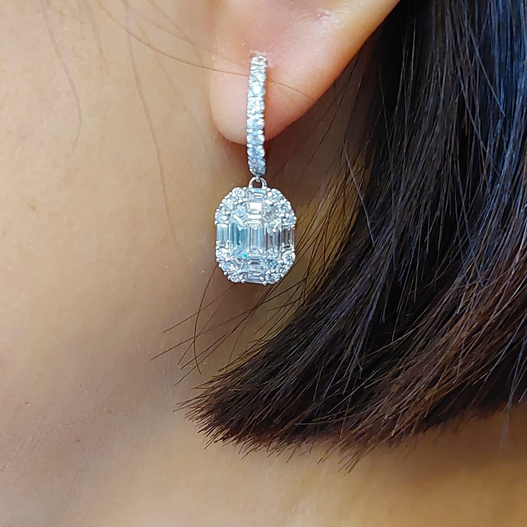 These shimmering drop earrings are a terrific finish to an already-beautiful anytime looks. Crafted in 18k white gold, each earring features in sparkling diamonds. Buffed to a brilliant luster, these earrings secure with lever backs.

This earring