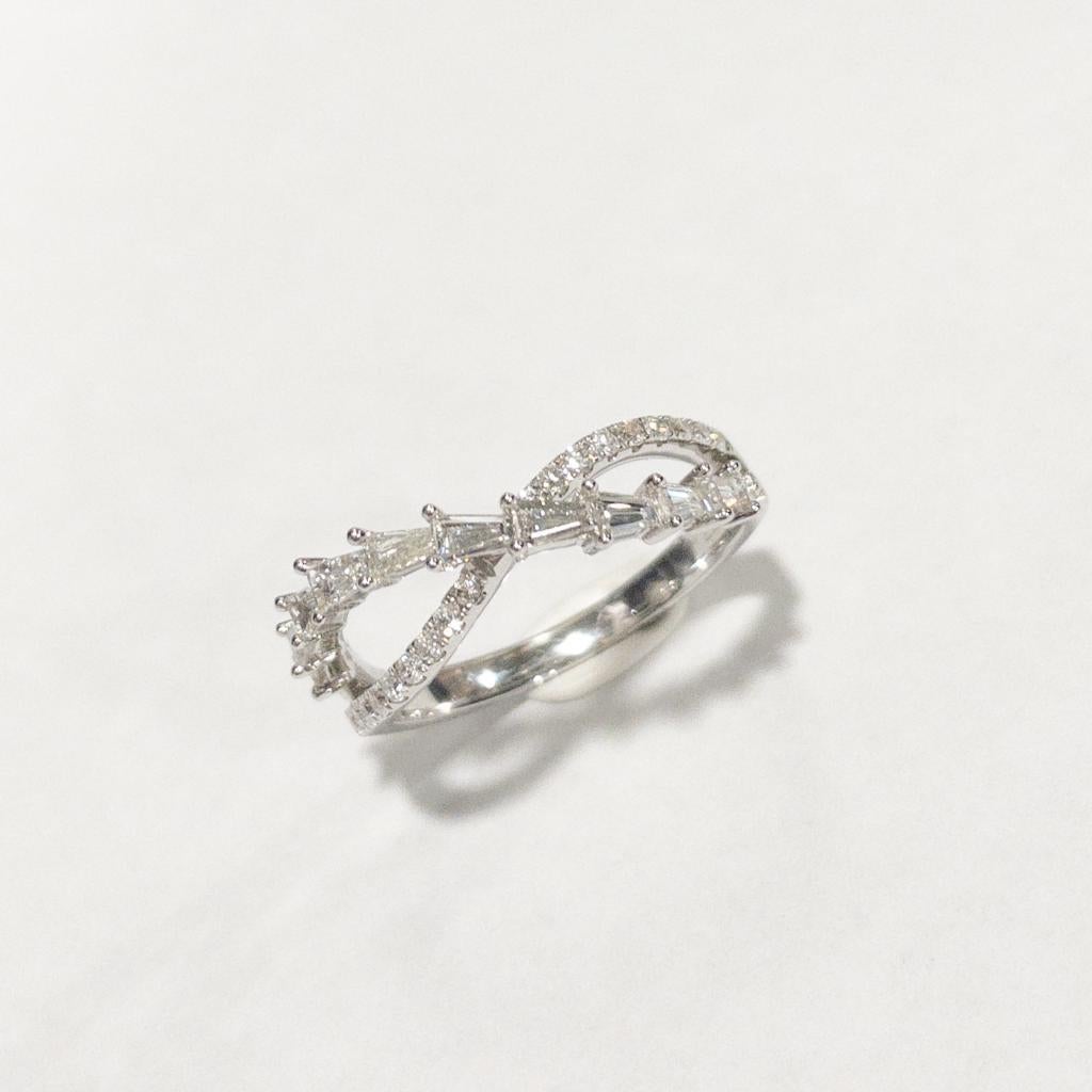 This crisscross 18K white gold diamond ring features taper-cut and round brilliant-cut diamonds, totaling 29 pieces of diamonds and weighing 0.65 carats. It is perfect with for casual ,business dress or a good choice of engagement ring. 
