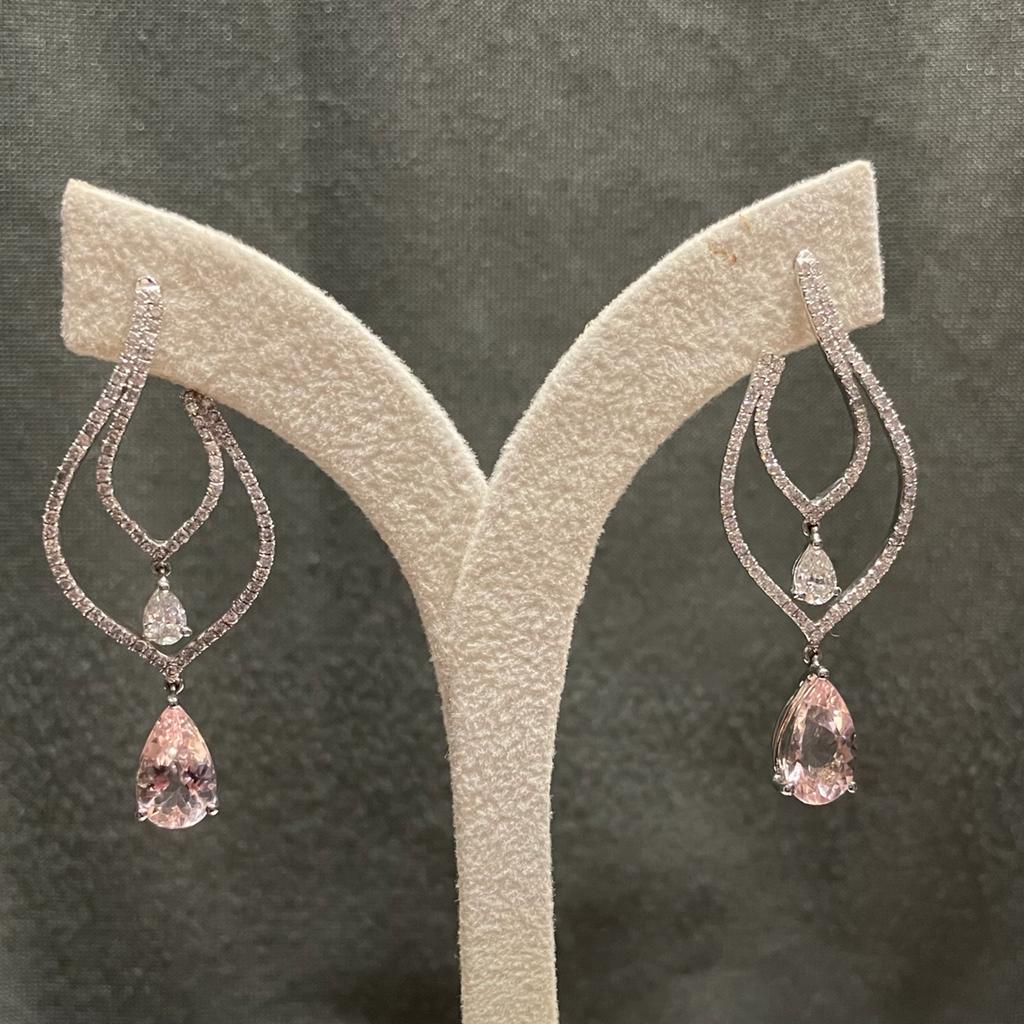 
A stunning pair of pear shaped Morganites fascinates with their soft peachy pink colour. They are beautifully offset by this diamond fittings. The morganites weigh a total of 4.11 carats ,the round brilliant-cut diamond weight is 1.14 carats, total