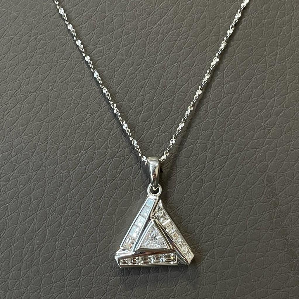 This triangle shaped diamond pendant necklace is the perfect great gift for someone special or add to your own personal collection. This pendant necklace setting with totaling 15 pieces of baguette and triangle diamonds, weighing 0.60 carats. Made