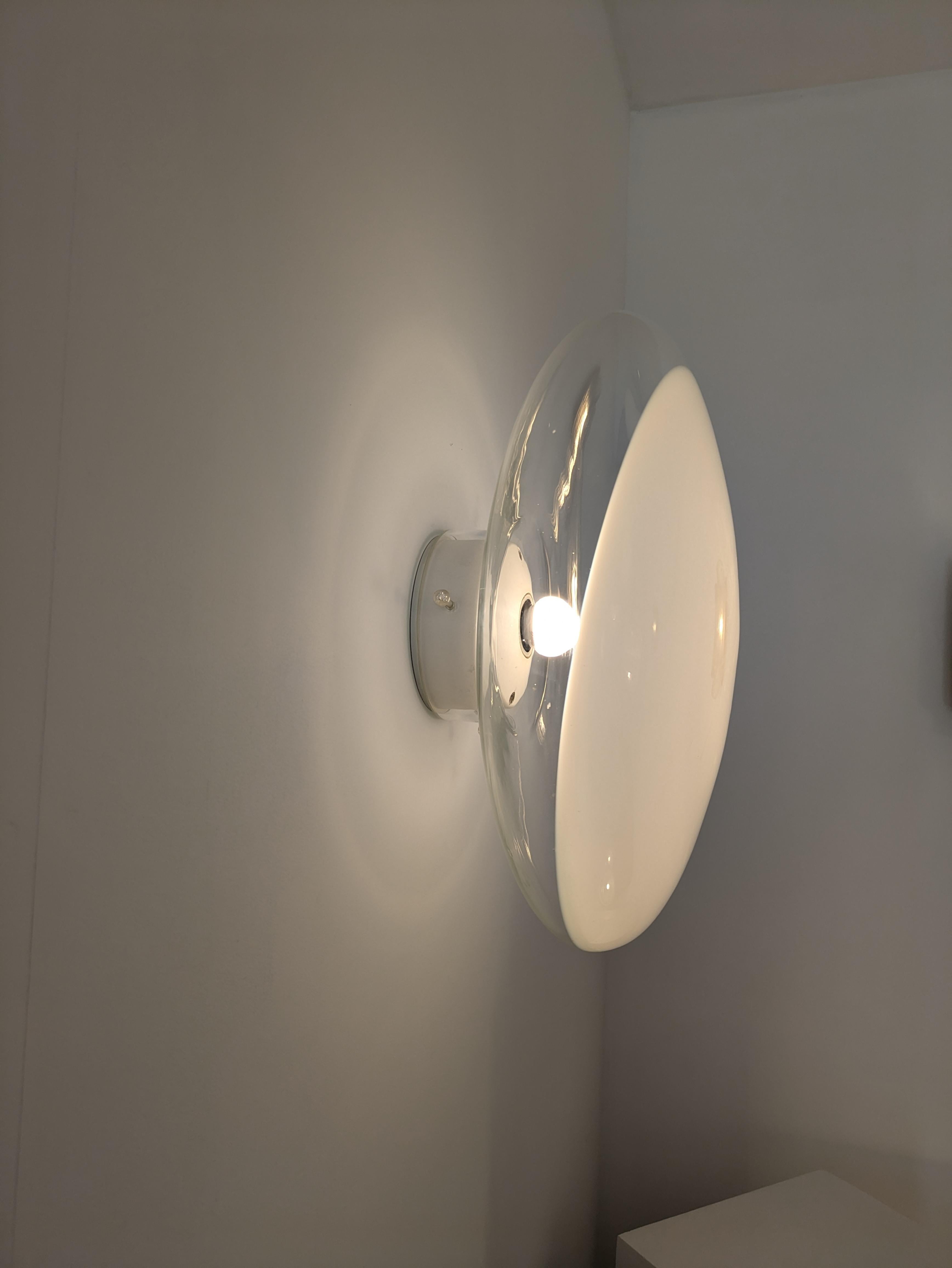 The Gill model of Leucos designed by Roberto Pamio is the first light produced by the company in 1962, a simple crystal blown globe with a milky opaline dot in it's middle. 
Declined in 4 diameters : 28cm, 35cm, 40cm and 45cm and 3 mountings, two in