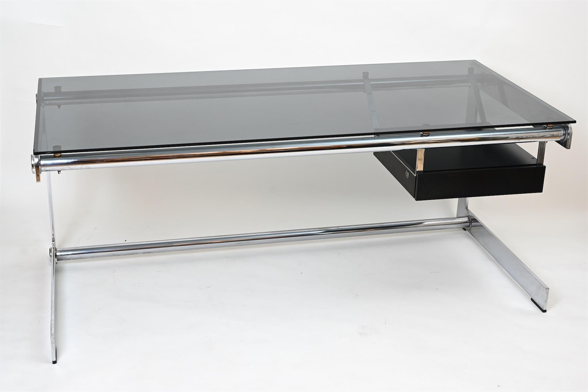 Midcentury French desk... The larger of this model 180 cm x 87.5 (depth)

Sleek Minimalist desk in chrome and glass with a single suspended drawer. By French architect Gilez Bouchez, circa 1965.