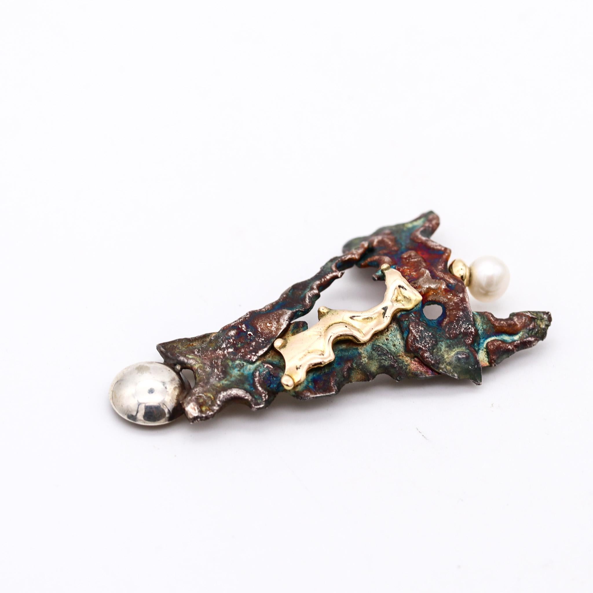An organic brooch designed by Gilles Maurel.

An intricate organic piece of jewelry, created in Quebec Canada by the artist jewelers Gilles Maurel, back in the late 1980. This brooch has been crafted with organic and free shapes motifs in patinated