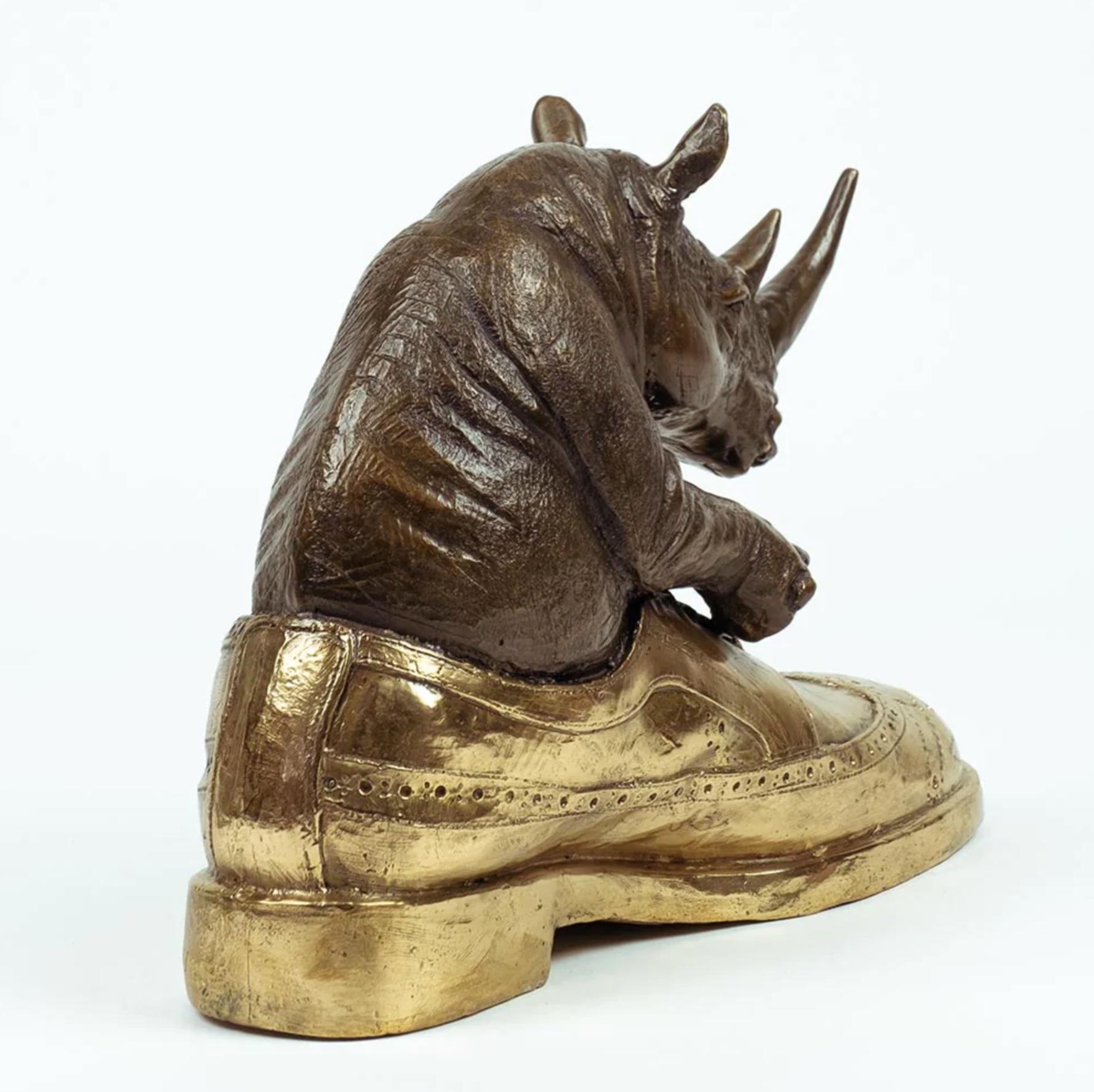 Title: Walk with the rhino
Authentic bronze sculpture

This authentic bronze sculpture titled 'Walk with the rhino' by artists Gillie and Marc has been meticulously crafted in bronze. It features a a rhino sitting in a shoe and comes in a