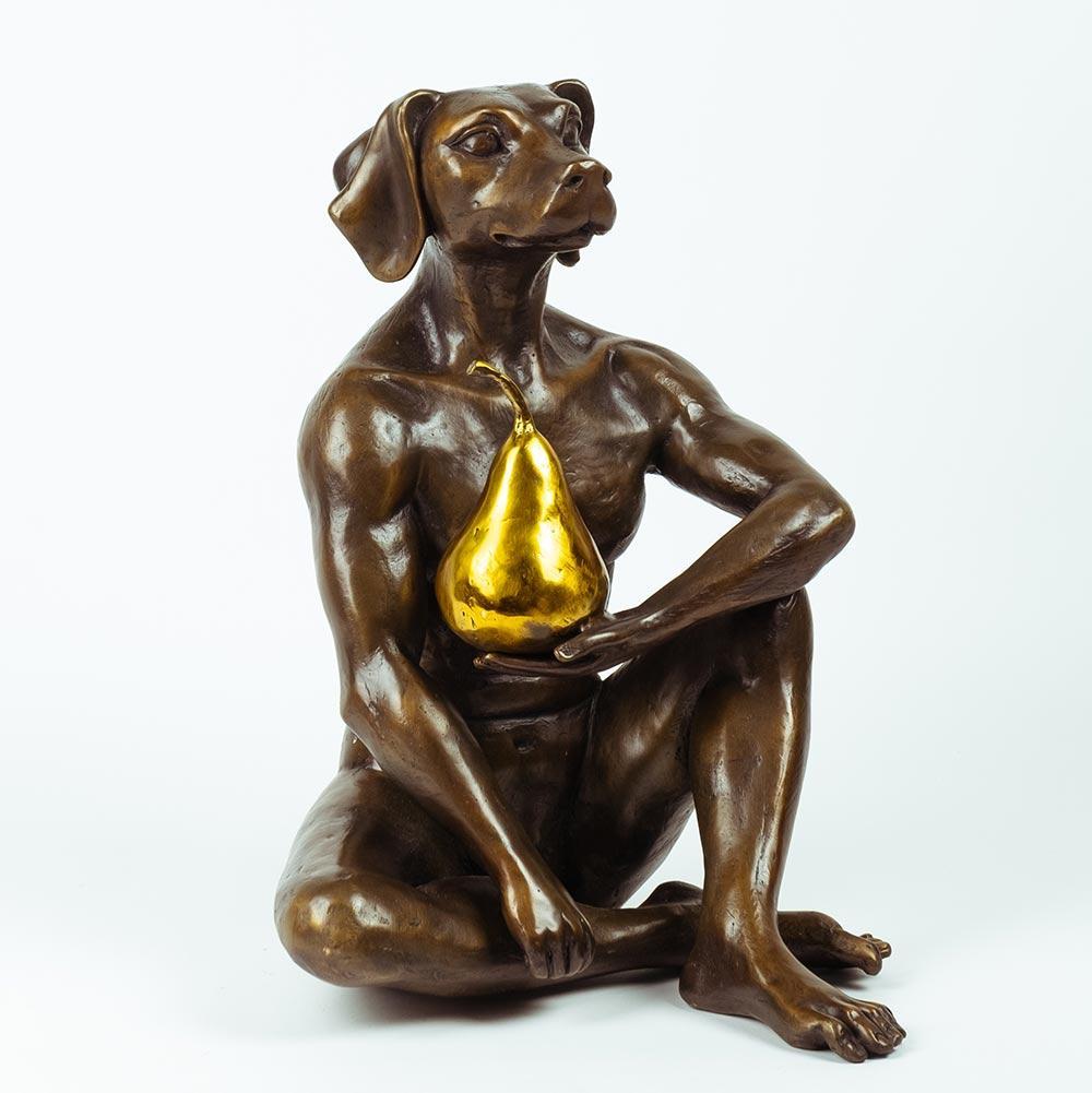 Title: Dogman thought a pear in the hand is worth two in the bush
Authentic bronze sculpture with gold patina
Limited Edition / 15

Dogman sits in his meditative way contemplating life with the pear in his hand. ‘How lucky I am to have this pear!”