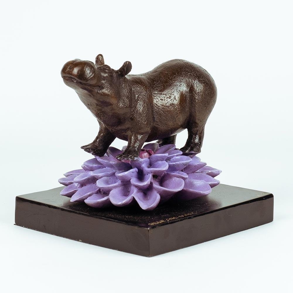 Title: The hippo was in bloom
Authentic bronze sculpture

This authentic bronze sculpture titled 'The hippo was in bloom' by artists Gillie and Marc has been meticulously crafted in bronze. It features a Hippo standing on a flower and comes in a