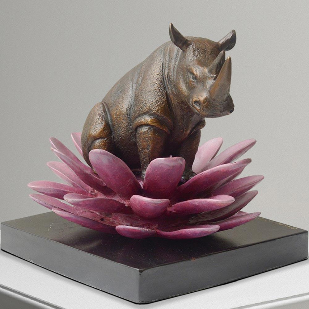 Title: The rhino was in bloom
Authentic bronze sculpture

This authentic bronze sculpture titled 'The hippo was in bloom' by artists Gillie and Marc has been meticulously crafted in bronze. It features a Hippo standing on a flower and comes in a