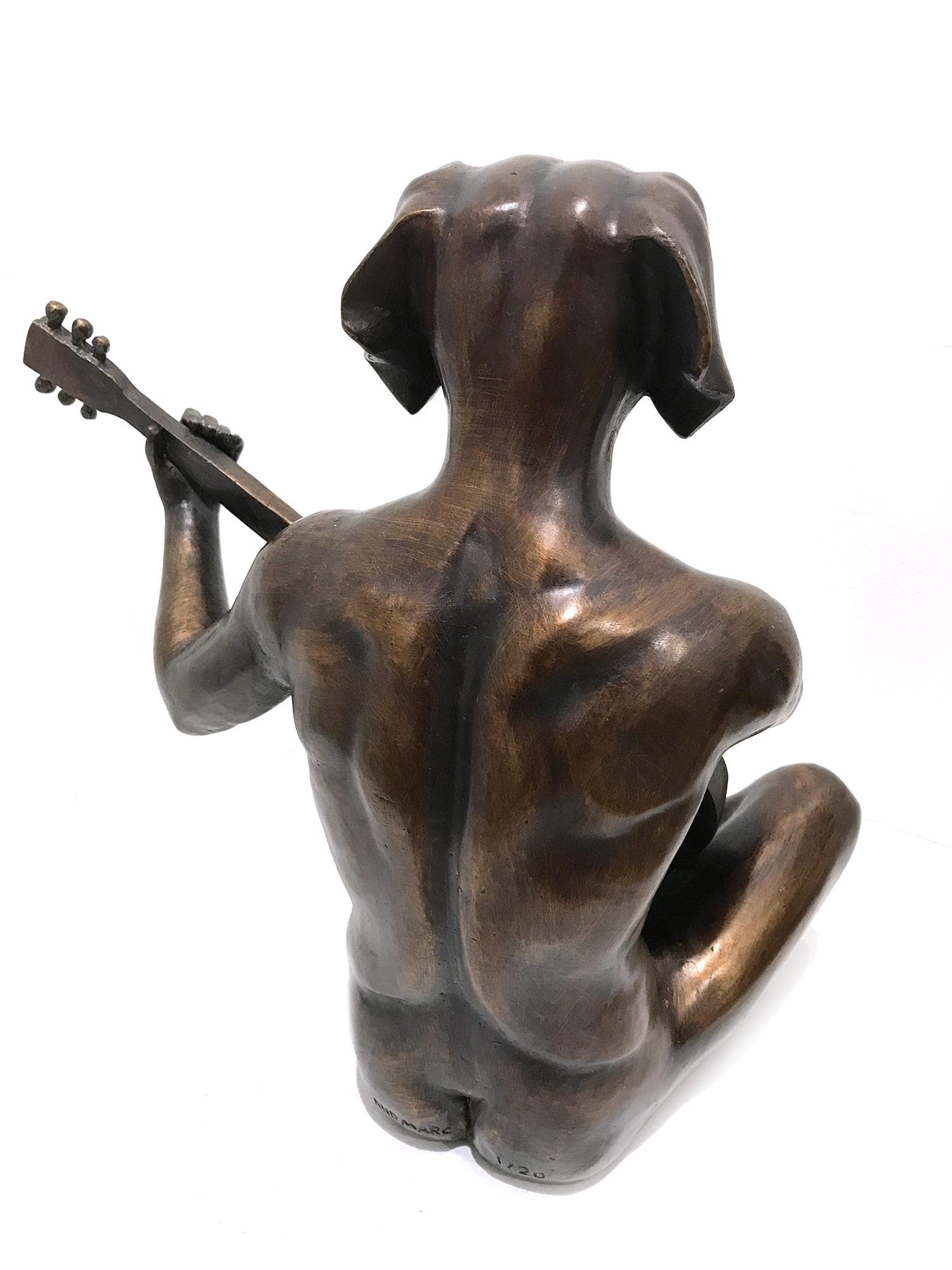 A whimsical yet very strong piece depicting the Dog Man from Gillie and Marc's iconic figures of the Dog/Bunny Human Hybrid, which has picked up much esteem across the globe. Here we find Dog Man seated while playing the guitar. The artists want to