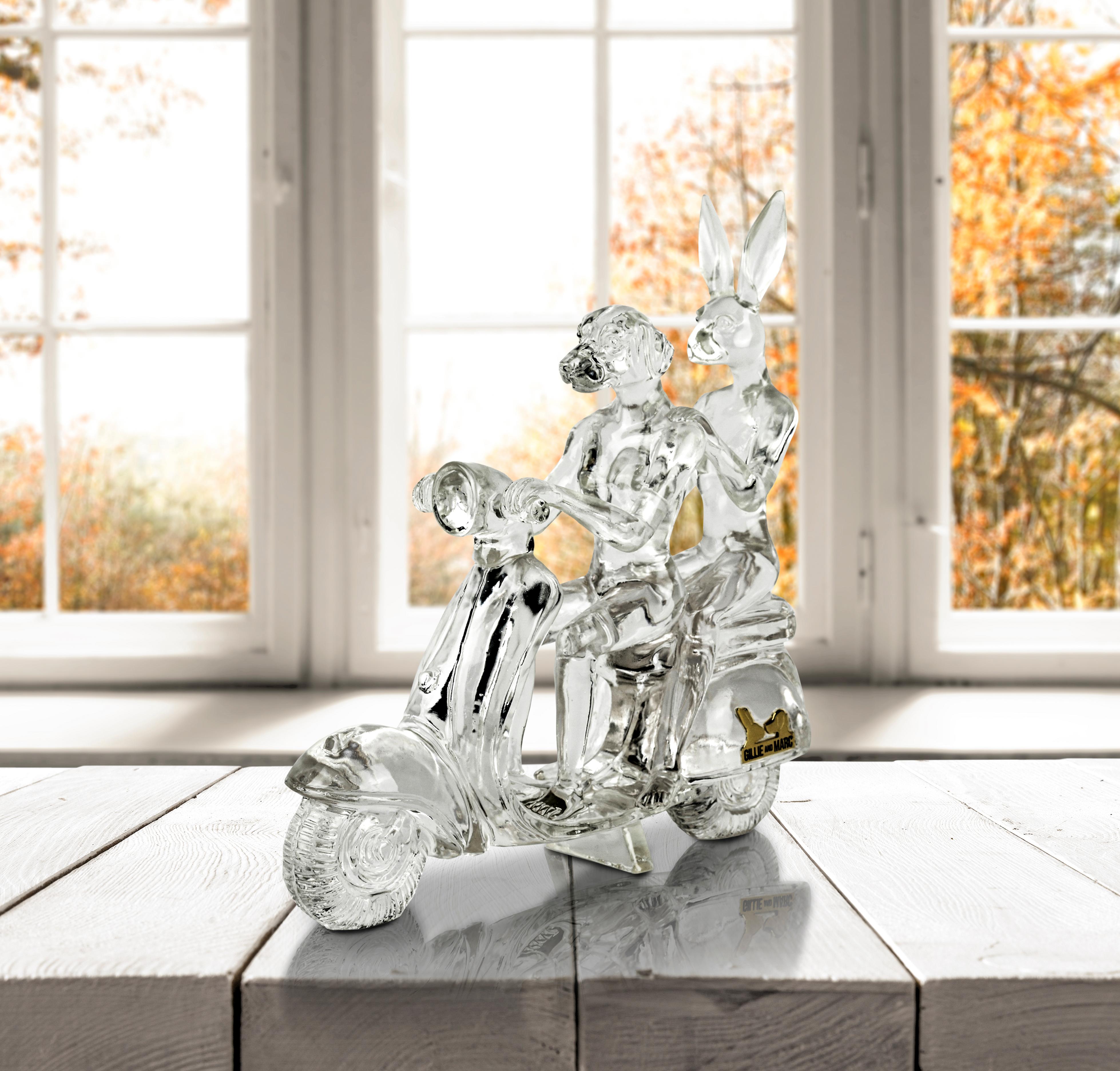 Title: Lolly happy mini vespa rider in Clear 
Authentic resin sculpture

This authentic resin sculpture titled 'Lolly happy mini vespa riders' in clear by artists Gillie and Marc has been meticulously crafted in resin. It features a Gillie and Marc