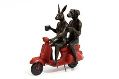 Their morning ride started with coffee and a kiss - playful, bronze sculpture