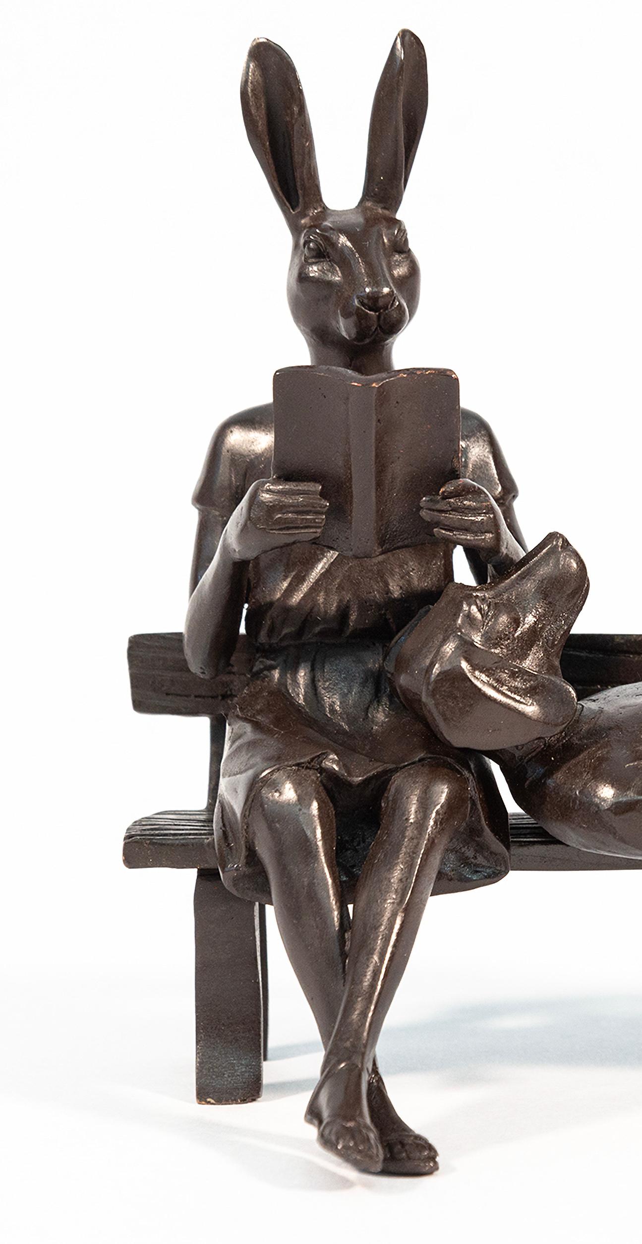 Captured reading books, this contemporary bronze figurative sculpture is by Gillie and Marc.

The British/Australian artistic duo of Gillie and Marc’s humorous bronze sculptures have charmed the world. Their own animal/human hybrid couple—dogman and
