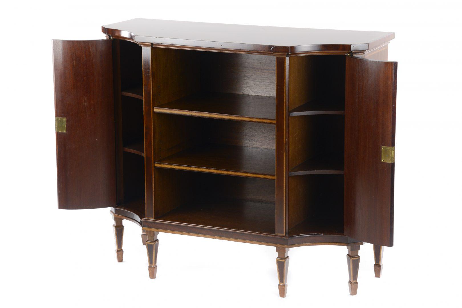 Gillows – A late 19th century mahogany inlaid low open bookcase cabinet, of shaped outline, banded in satinwood bordered with boxwood and ebonised lines, having central open shelves flanked by an enclosed concave fronted cupboard to either side,