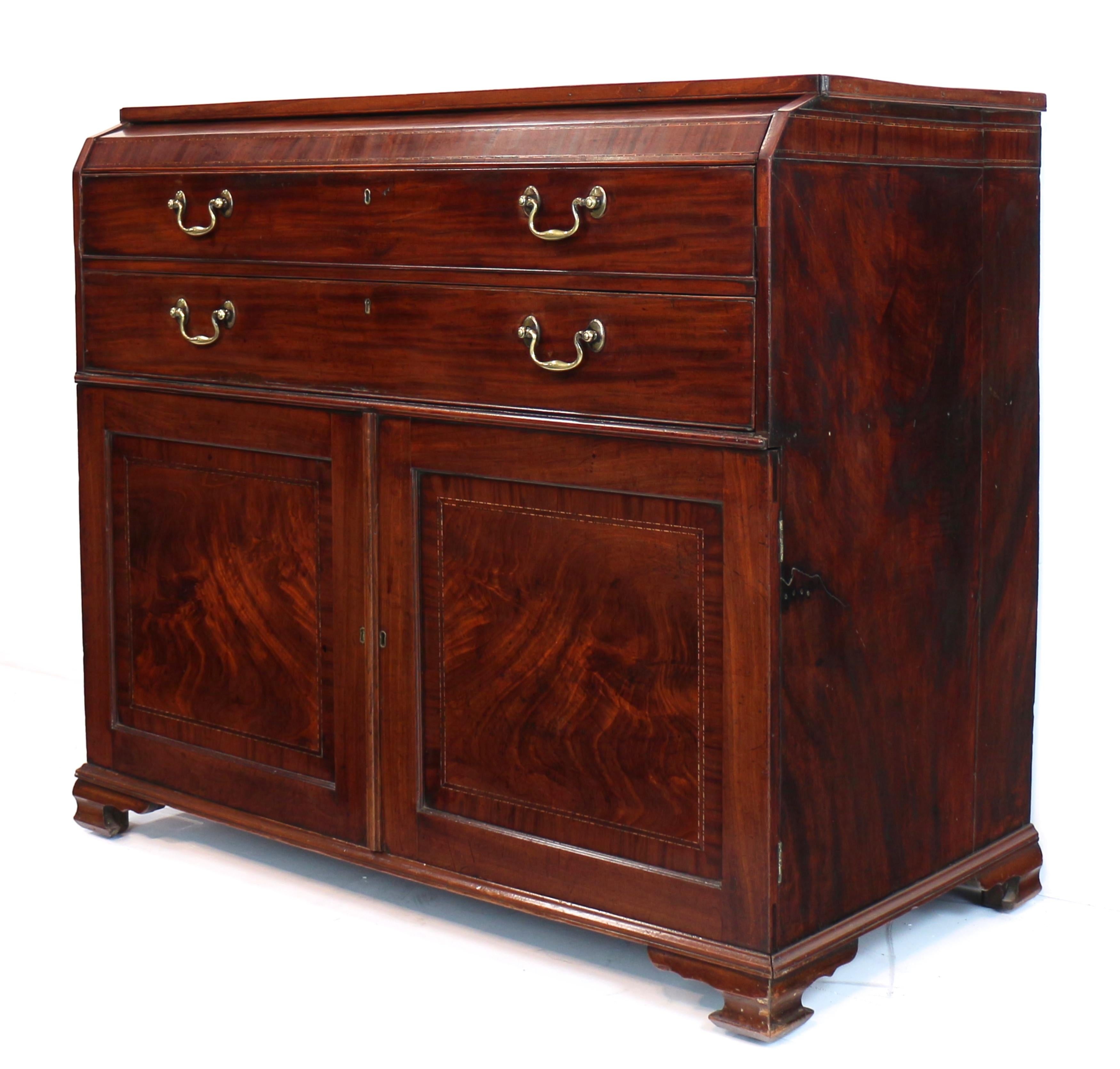 circa 1790.  With a rectangular top over a concealed long drawer with sloping front, mahogany crossbanding and parquetry and box stringing which continues across the top of the sides, the two long false drawer fronts below forming a deep secretaire