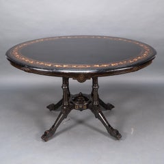 Gillows attr. An Aesthetic Movement tilt top dining table with floral inlays