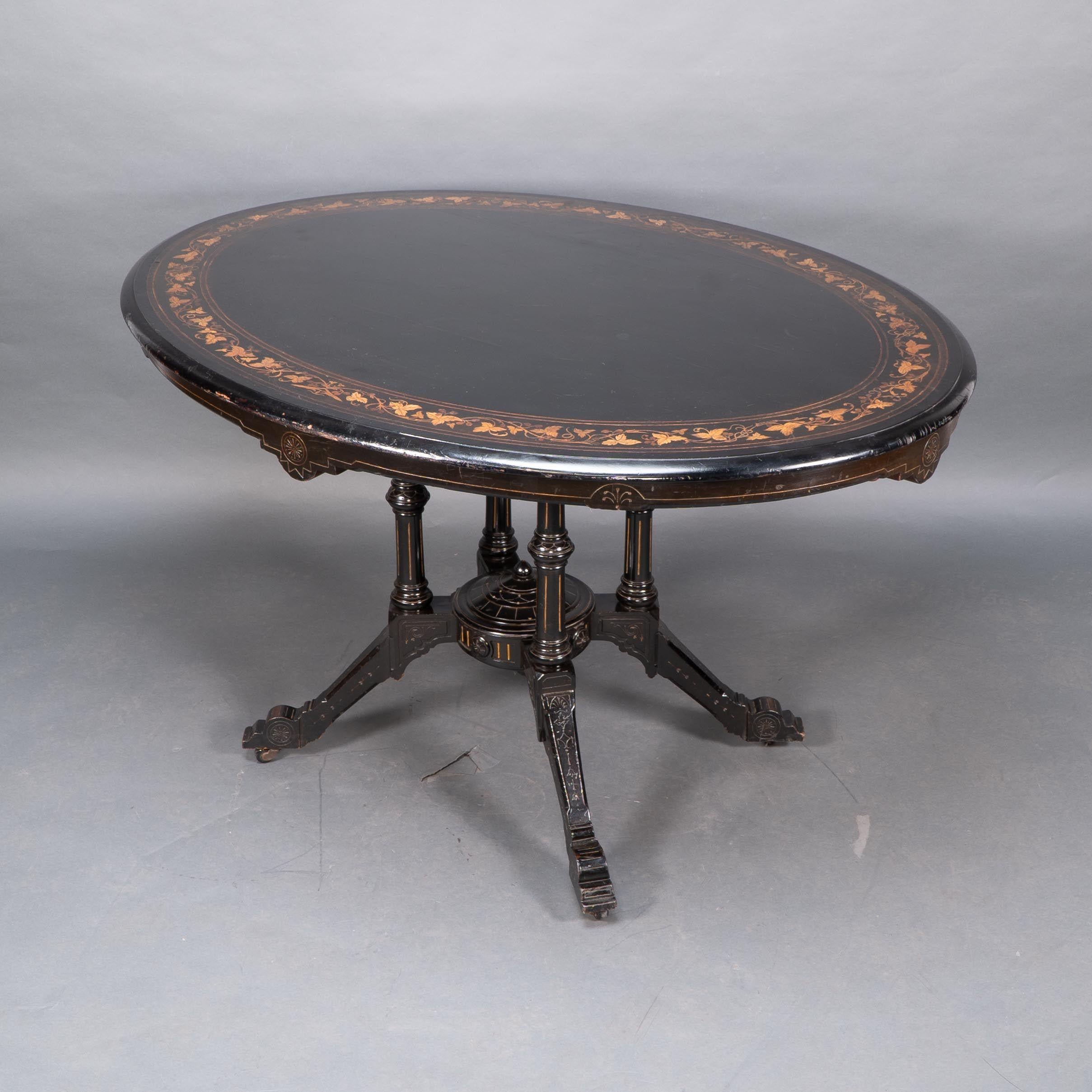 Ebonized Gillows attr. An Aesthetic Movement tilt top dining table with floral inlays For Sale