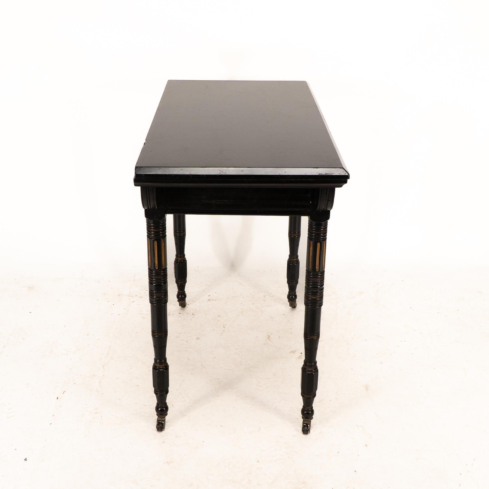 English Gillows attributed. An Aesthetic Movement ebonized games and card table For Sale