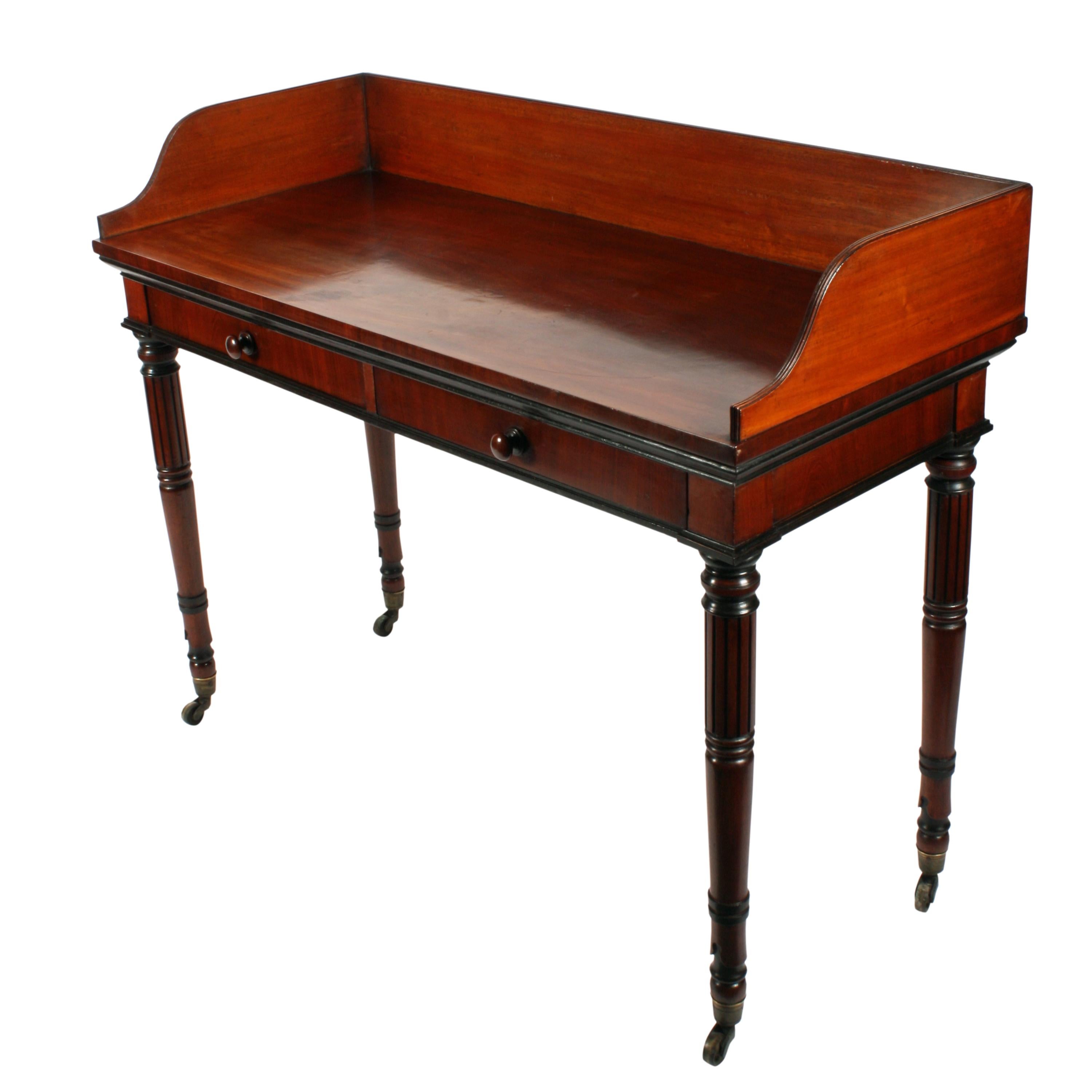 An early 19th century Georgian mahogany Gillows design mahogany two drawer side table.

The table has come from the estate of the Duke & Duchess of Northumberland and has an inventory number in the left hand drawer.

The table has a gallery back