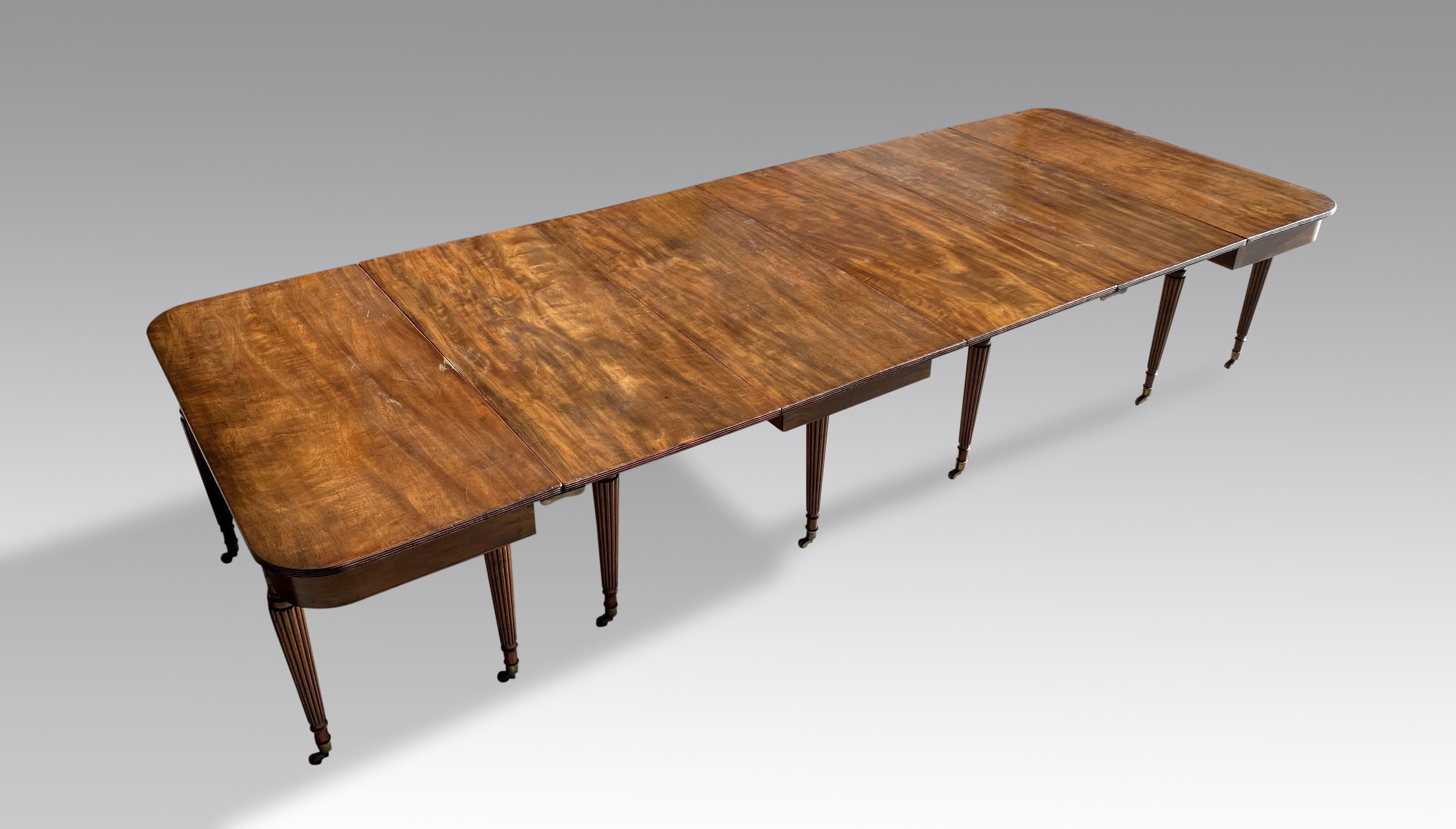 An outstanding George II period mahogany extending dining table attributed to Gillows of Lancashire and London.  In fine flame figured mahogany with three section drop leaf centre, two end sections and one extra leaf which attaches between one end