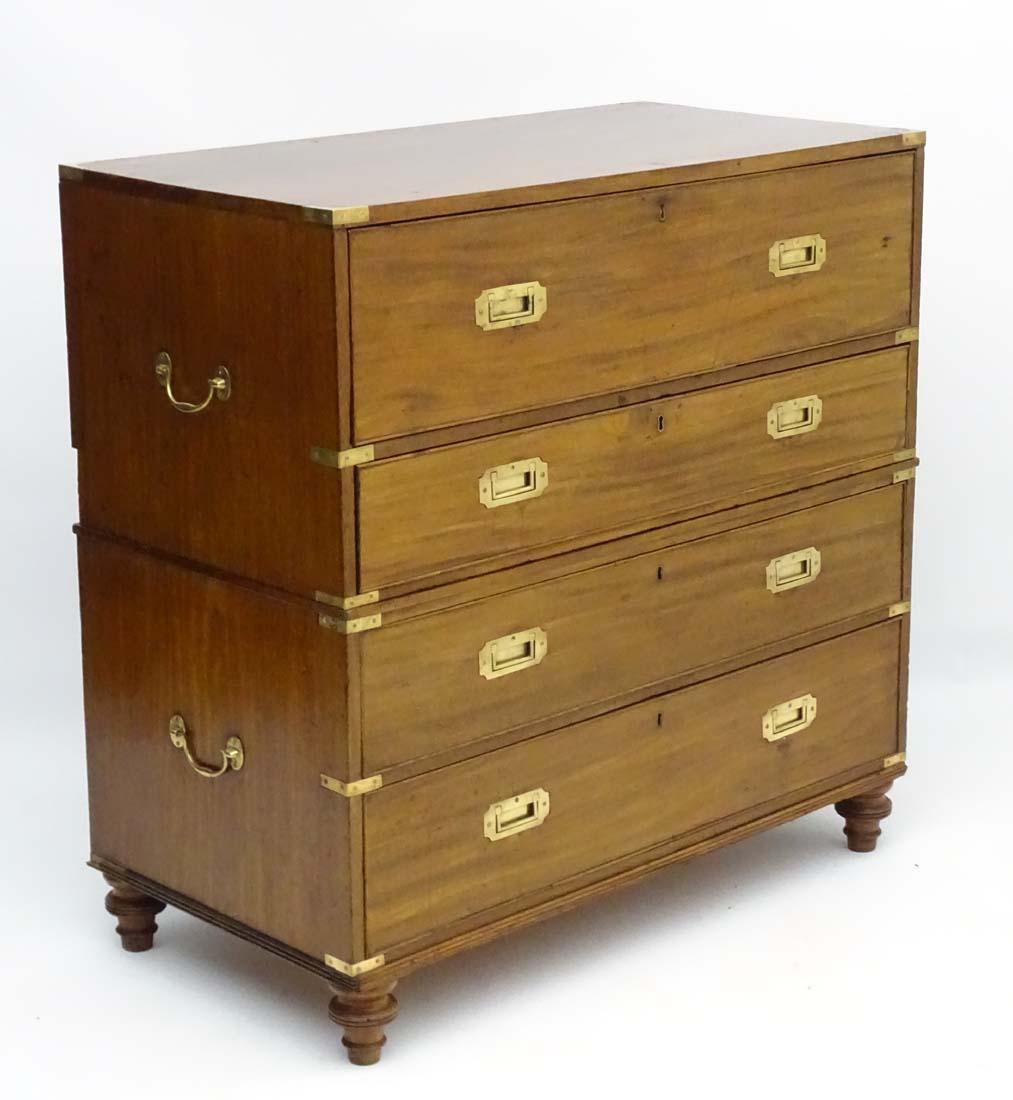 A magnificent and rare mid-19th century 'Gillows of Lancaster' two part Mahogany secretaire campaign chest of drawers circa 1850, the upper section of the chest having a pull out secretaire drawer enclosing a fully fitted interior with various