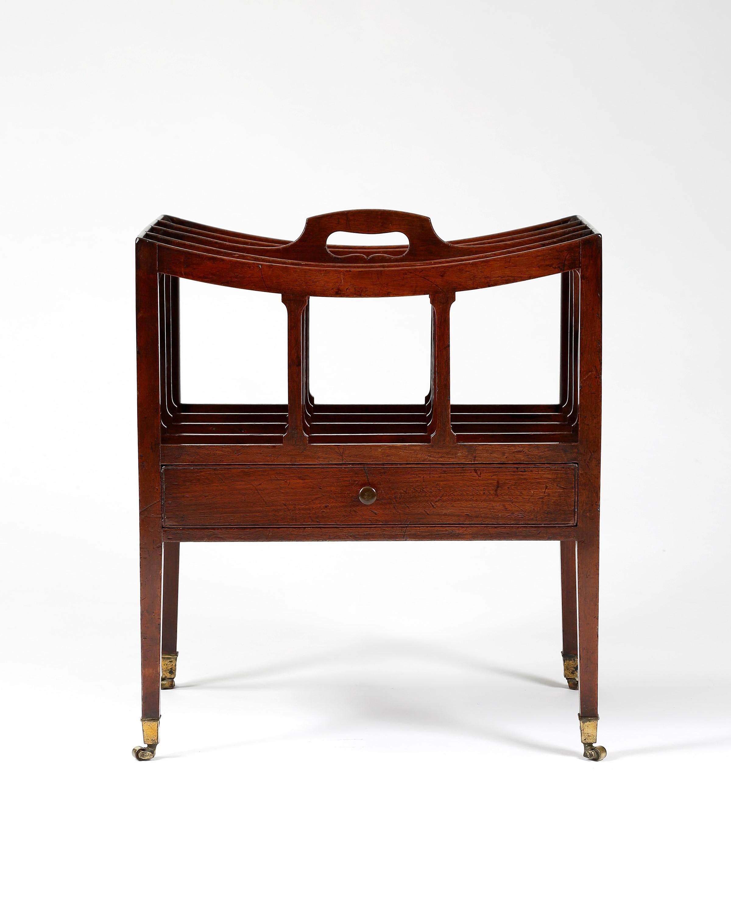 Mahogany music canterbury made by Gillows of Lancaster, with four slatted divisions, pierced carrying handle above a drawer. Raised on four square tapering legs onto barrel castors, English, 1800. Ref details page 91 Vol II Susan E. Stuart. Gillows