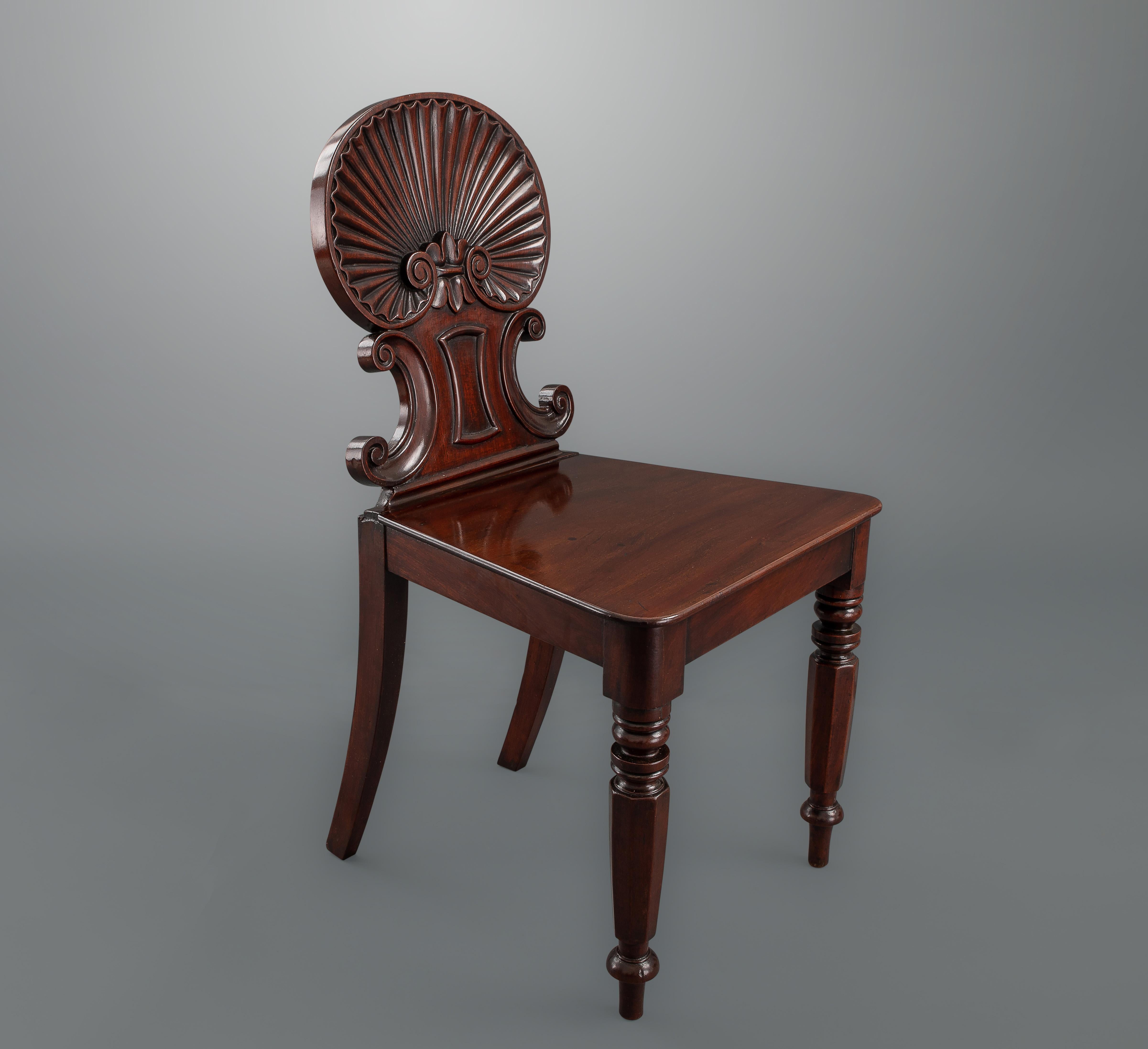A superb pair of shell-back mahogany chairs probably by Gillows of London and Lancaster with excellent carving and great color and patina. The chair backs, richly carved with Venus-shell and C-scrolls predate the robust antique style promoted by