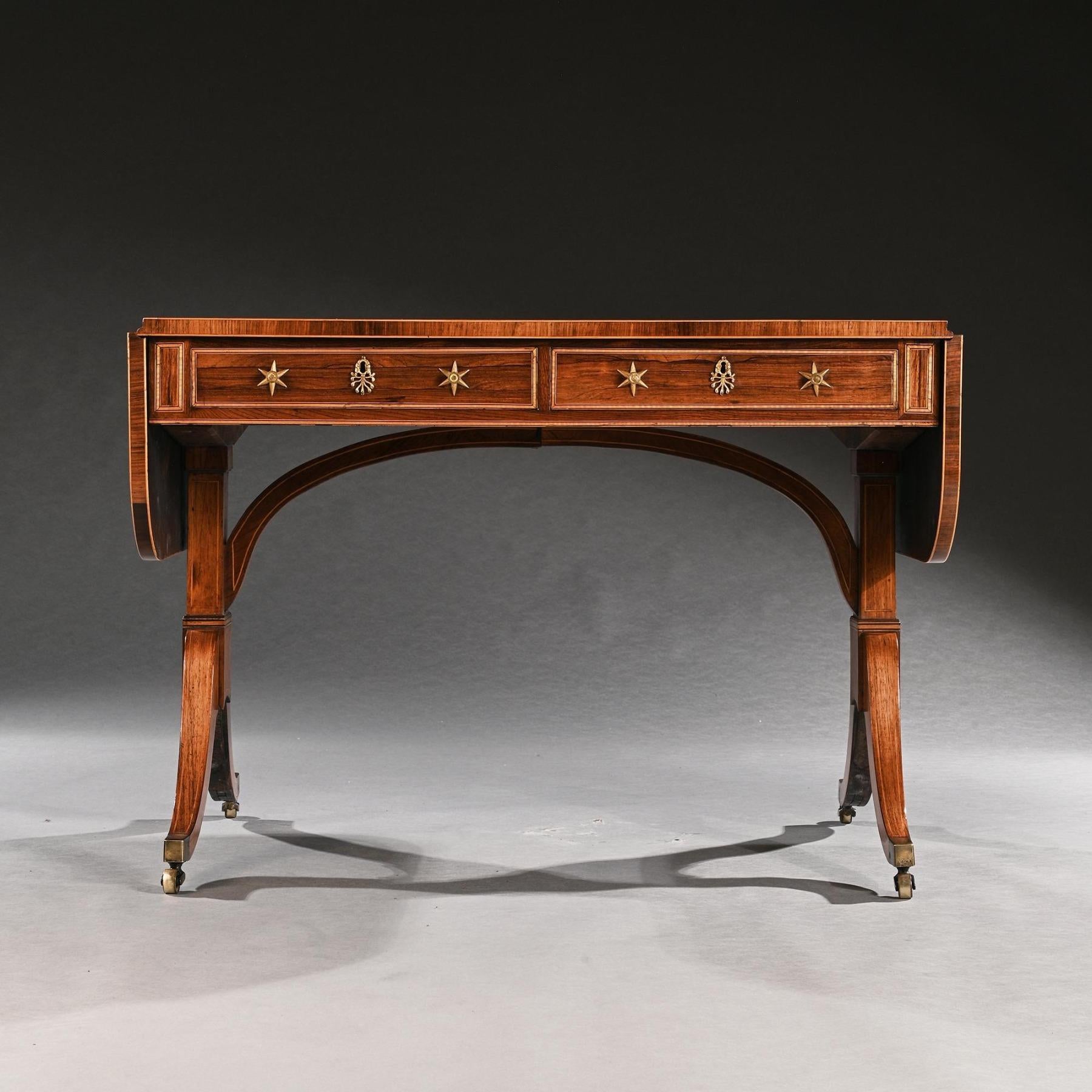 Extremely Fine Regency Rosewood and Casuarina Sofa table firmly attributed to Gillows of Lancaster, with John  Mclean pattern handles and escutcheons, of wonderful faded colour.

English Likely London made Circa 1810 

Of conventional form with two