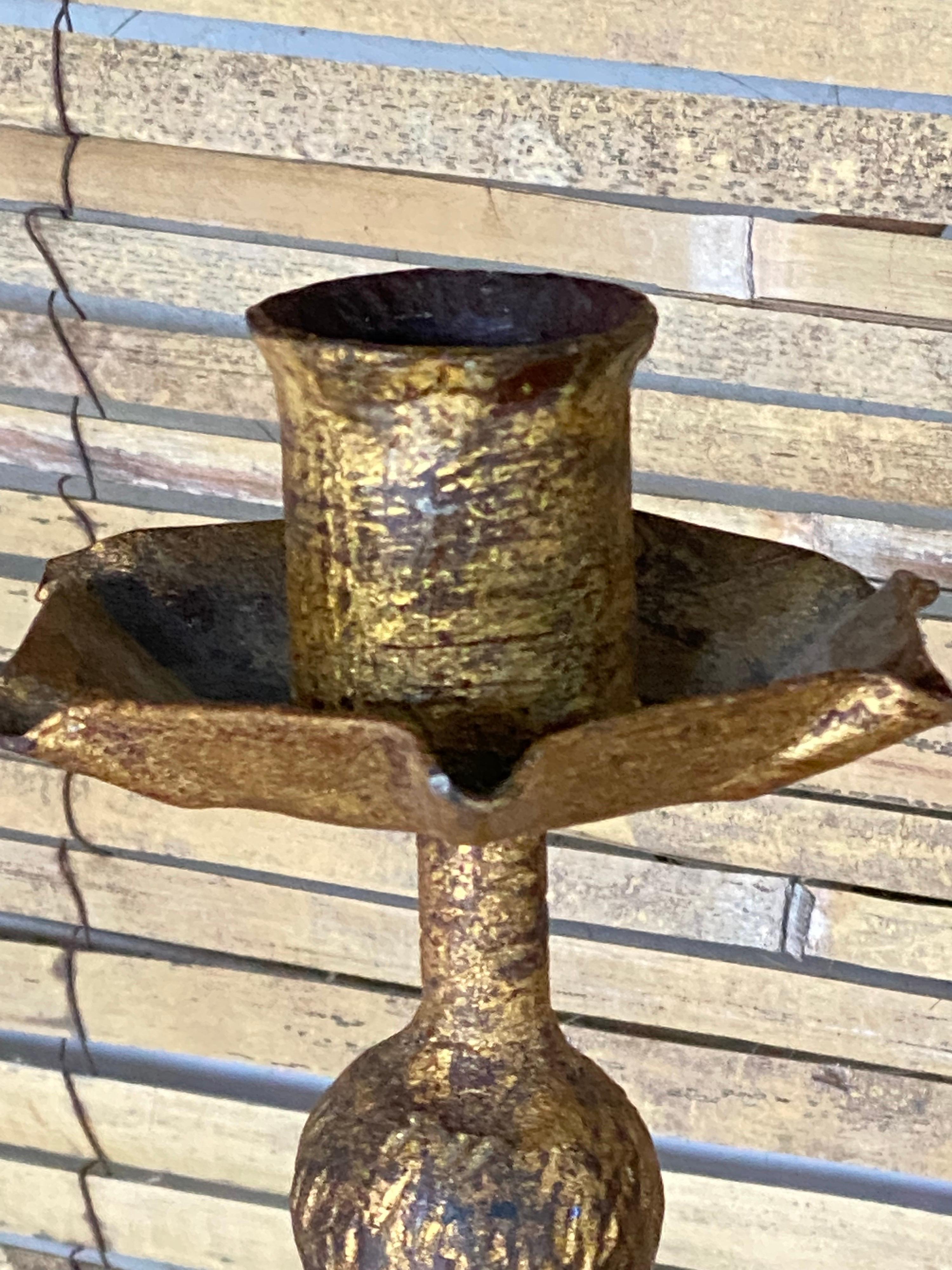 This candle holder is in iron with a gold color. It is heavy, and in a very good condition. The patina is beautiful.
It has been made in France in the 1970's.