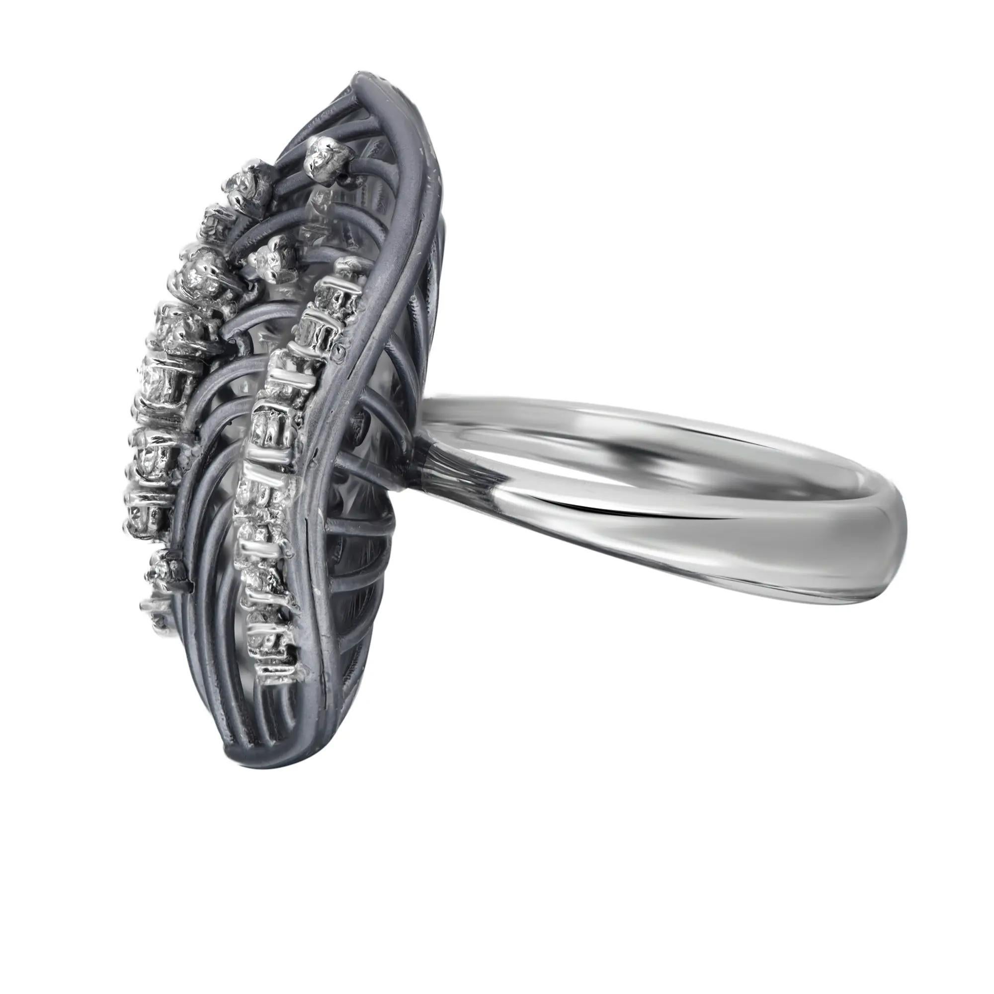 Sparkle with this diamond cocktail ring. The ring showcases an intricate wire openwork pattern in coated 18k white gold. Its round cut diamond stones are elegantly set in prong setting. Perfect gift for your loved ones. The width of the ring is 25.5