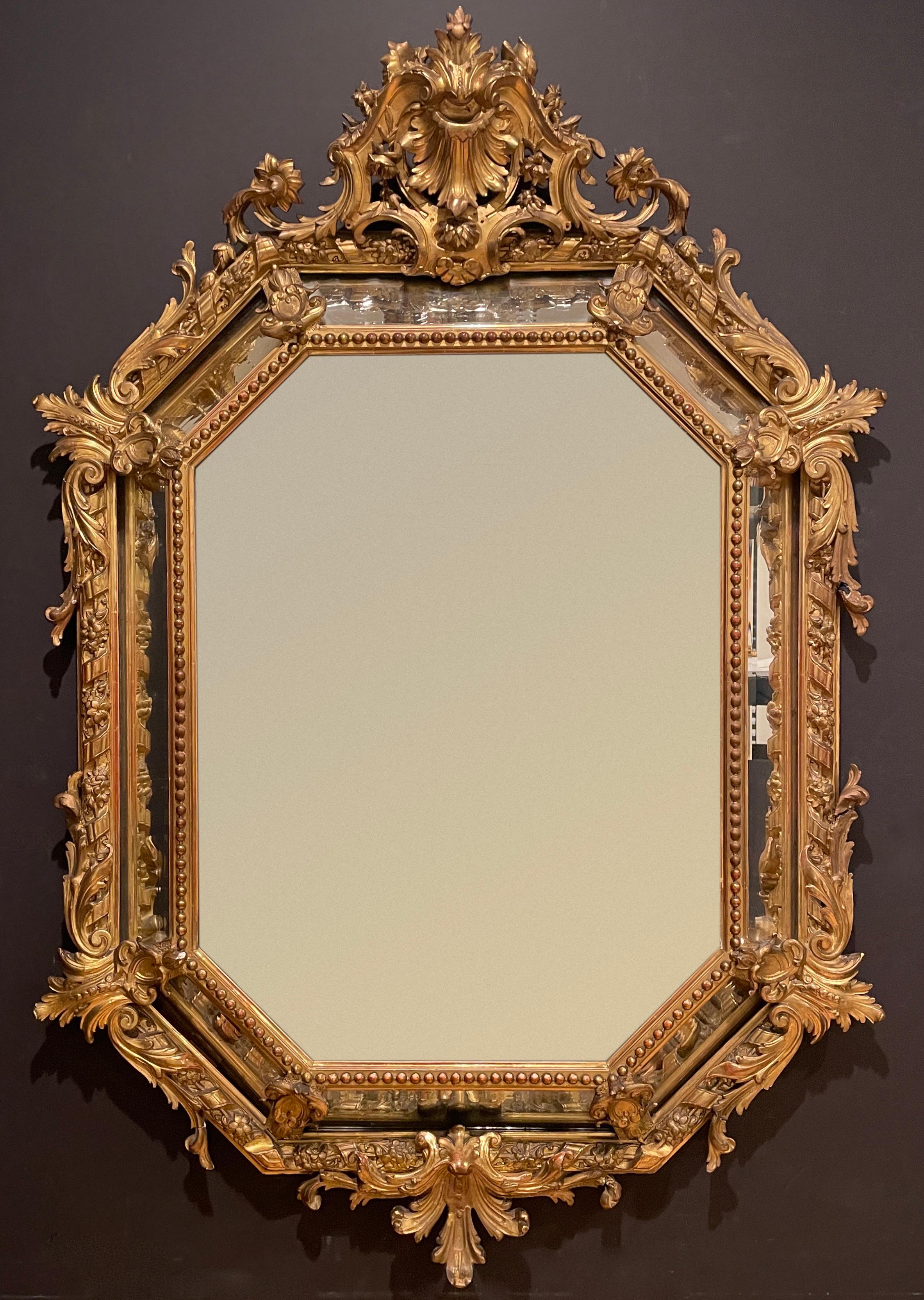 Fine quality giltwood and gesso 19th century center beveled marginal mirror of octangular shape with the makers mark P.B. and a double image. The cushion form and high relief of the elements have this mirror make a very impressive statement.