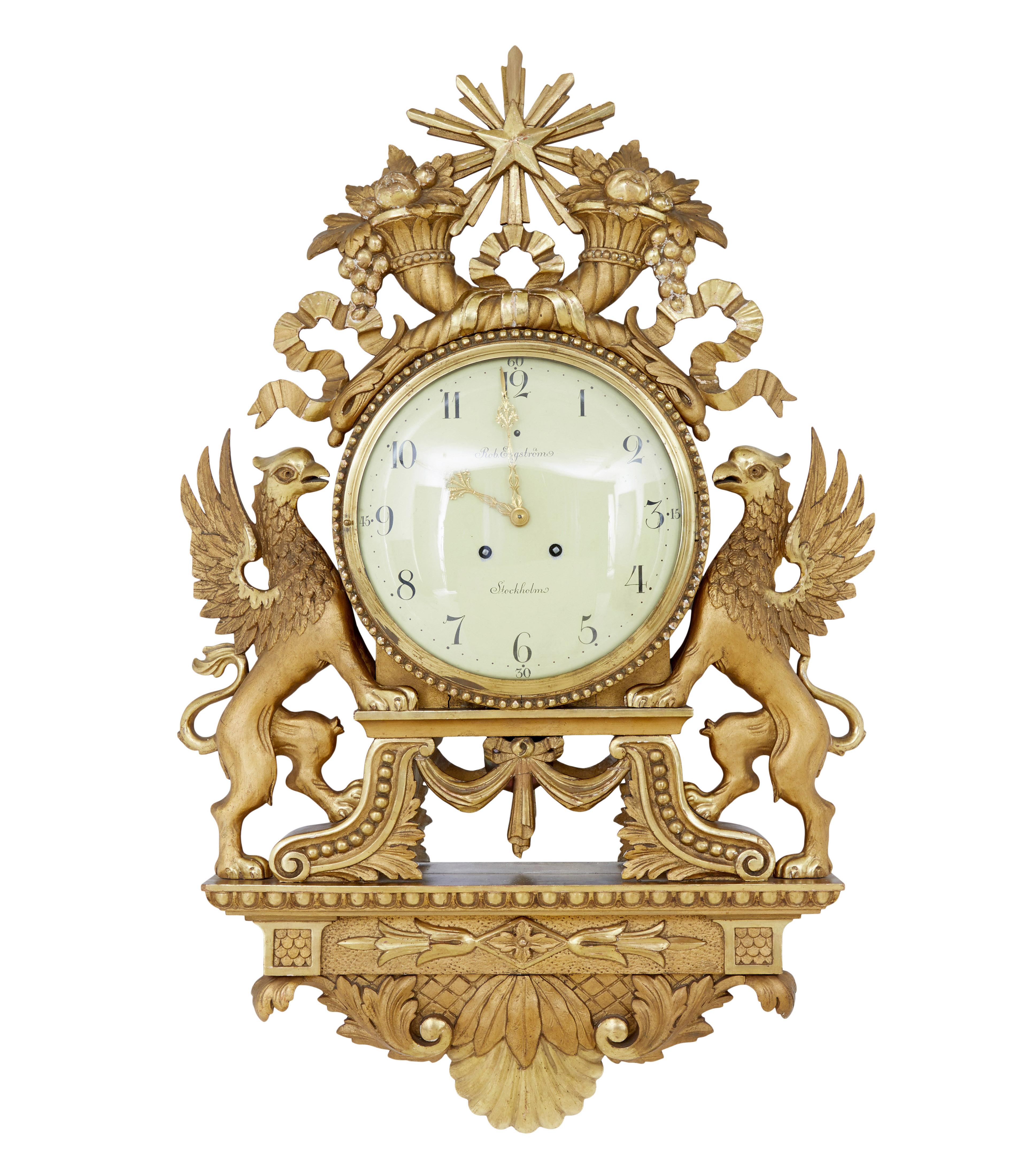 Gilt 19th century Swedish made wall clock of generous proportions circa 1895.

Here we have a neo classical clock by well known Swedish maker Rob Engstrom, who have been trading since 1832.  It is fitted with a German Lenzkirch 1 million movement, 