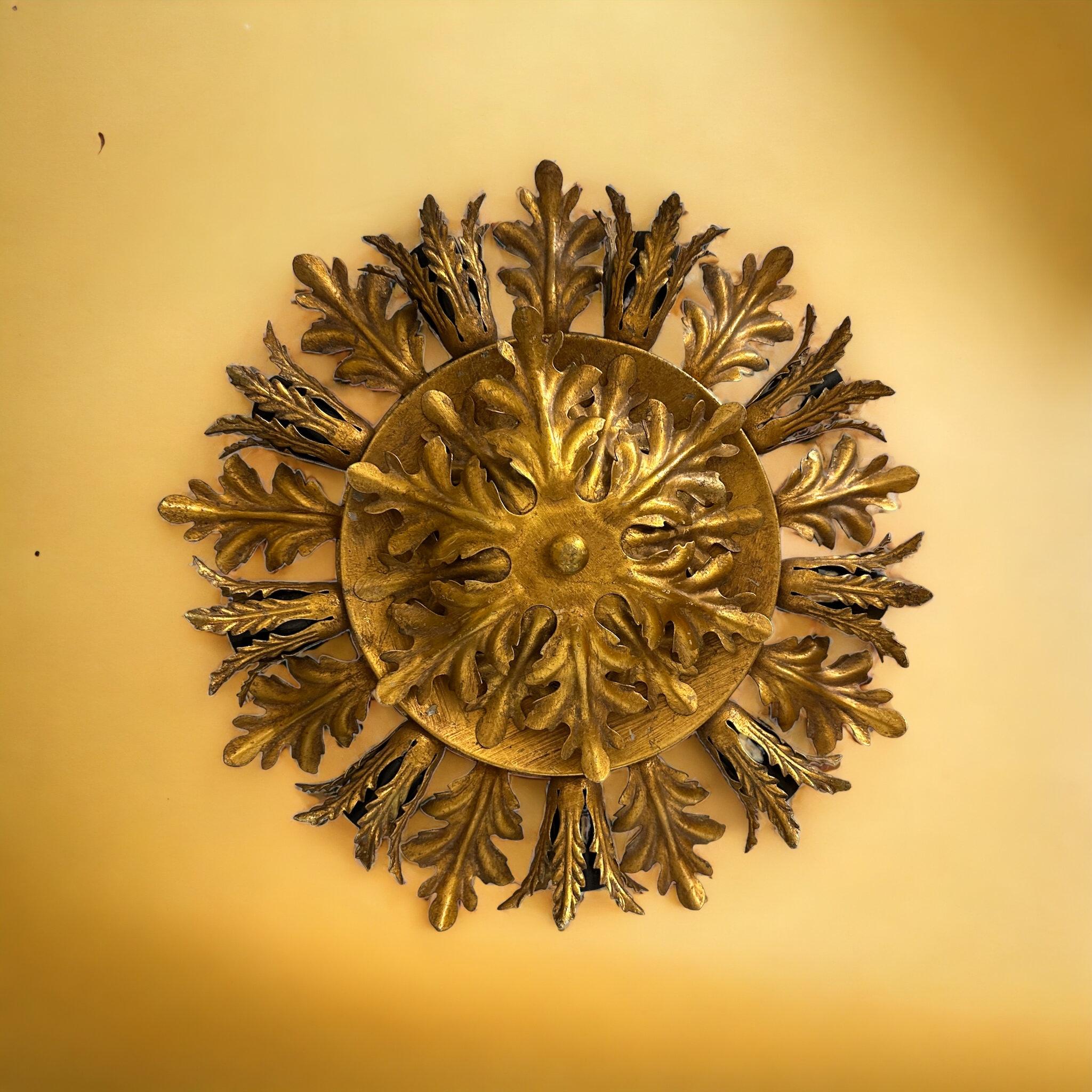 Add a touch of opulence to your home with this charming flush mount. Perfect gilt metal leafs to enhance any chic or eclectic home. We'd love to see it hanging in an entryway as a charming welcome home. Built in the 1960s, attributed to Banci