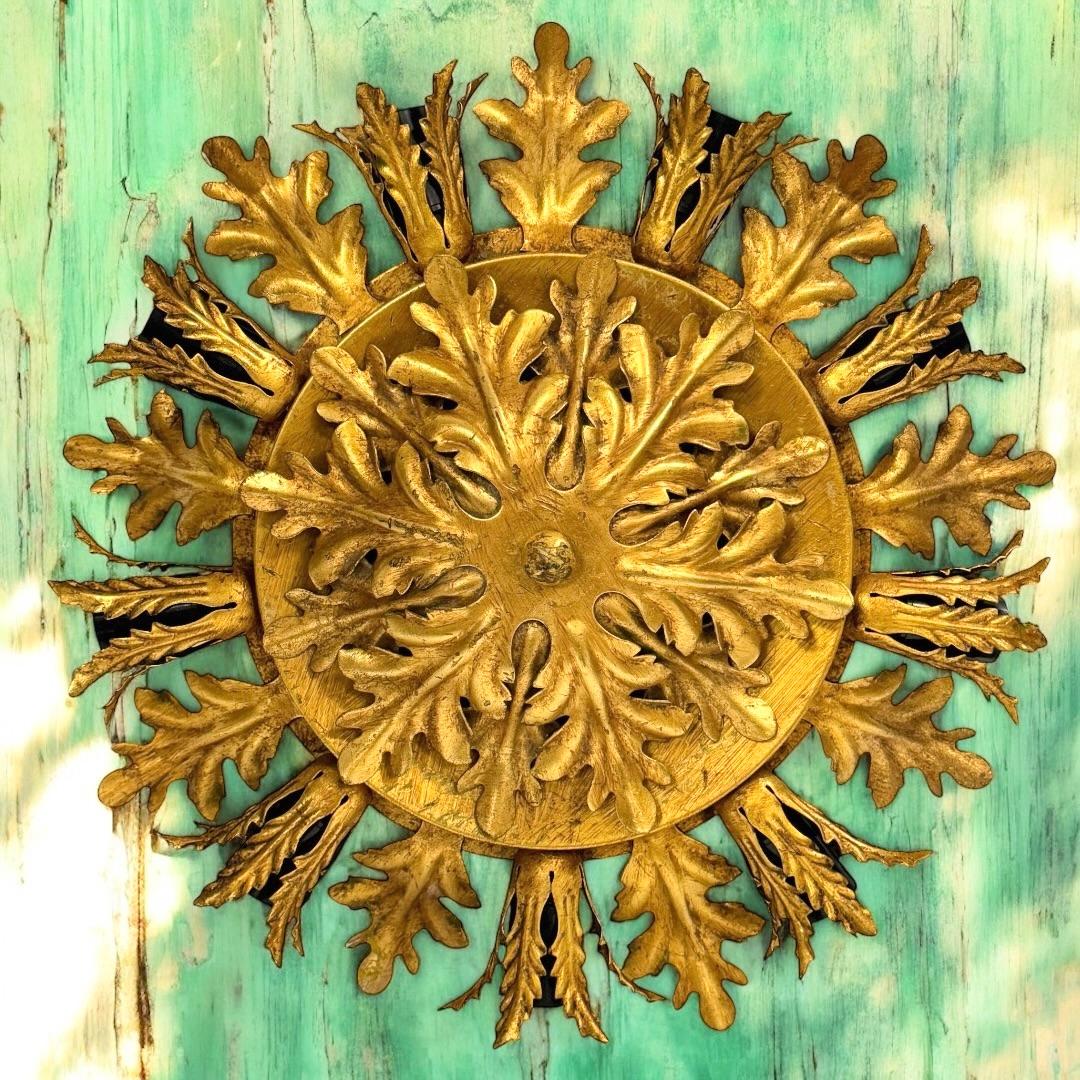 Add a touch of opulence to your home with this charming flush mount. Perfect gilt metal leafs to enhance any chic or eclectic home. We'd love to see it hanging in an entryway as a charming welcome home. Built in the 1960s, attributed to Banci