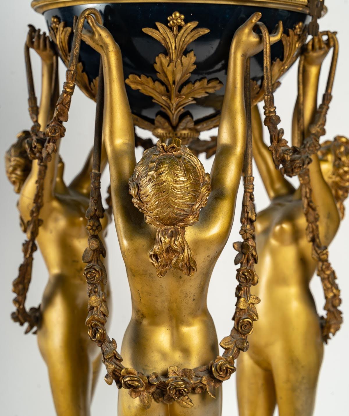 Gilt and Enameled Bronze Clock, White Marble, The Three Graces, Supporting a Globe Clock.

Important clock representing 