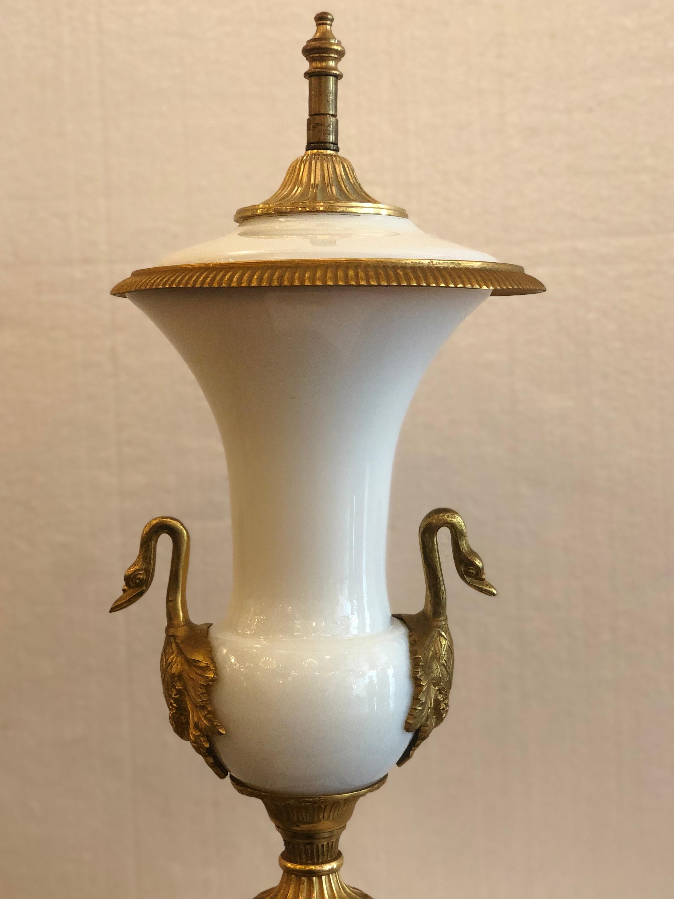 An Empire style gilt and opaline glass urn.