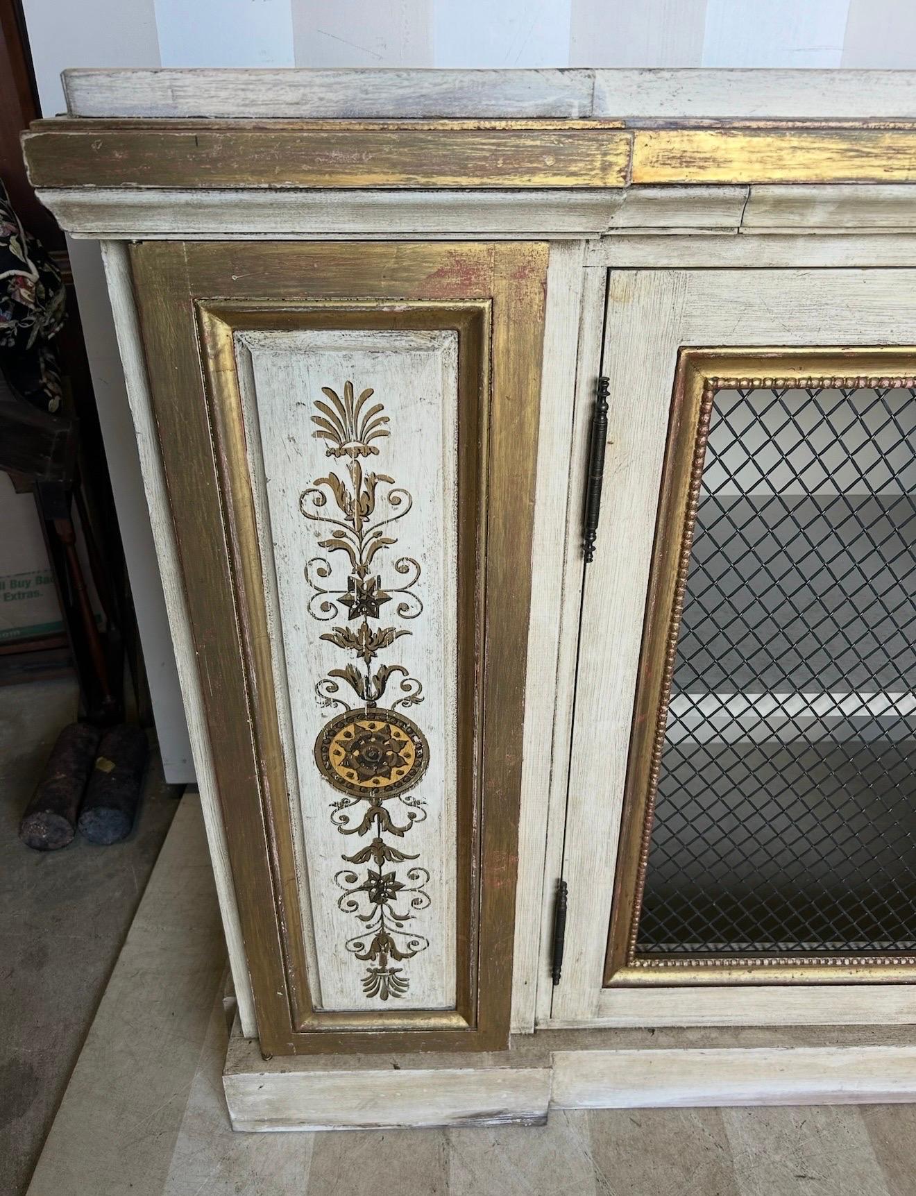 Gorgeous neoclassical style gilt and paint decorated cabinet, previously sold by the esteemed Newel in NYC