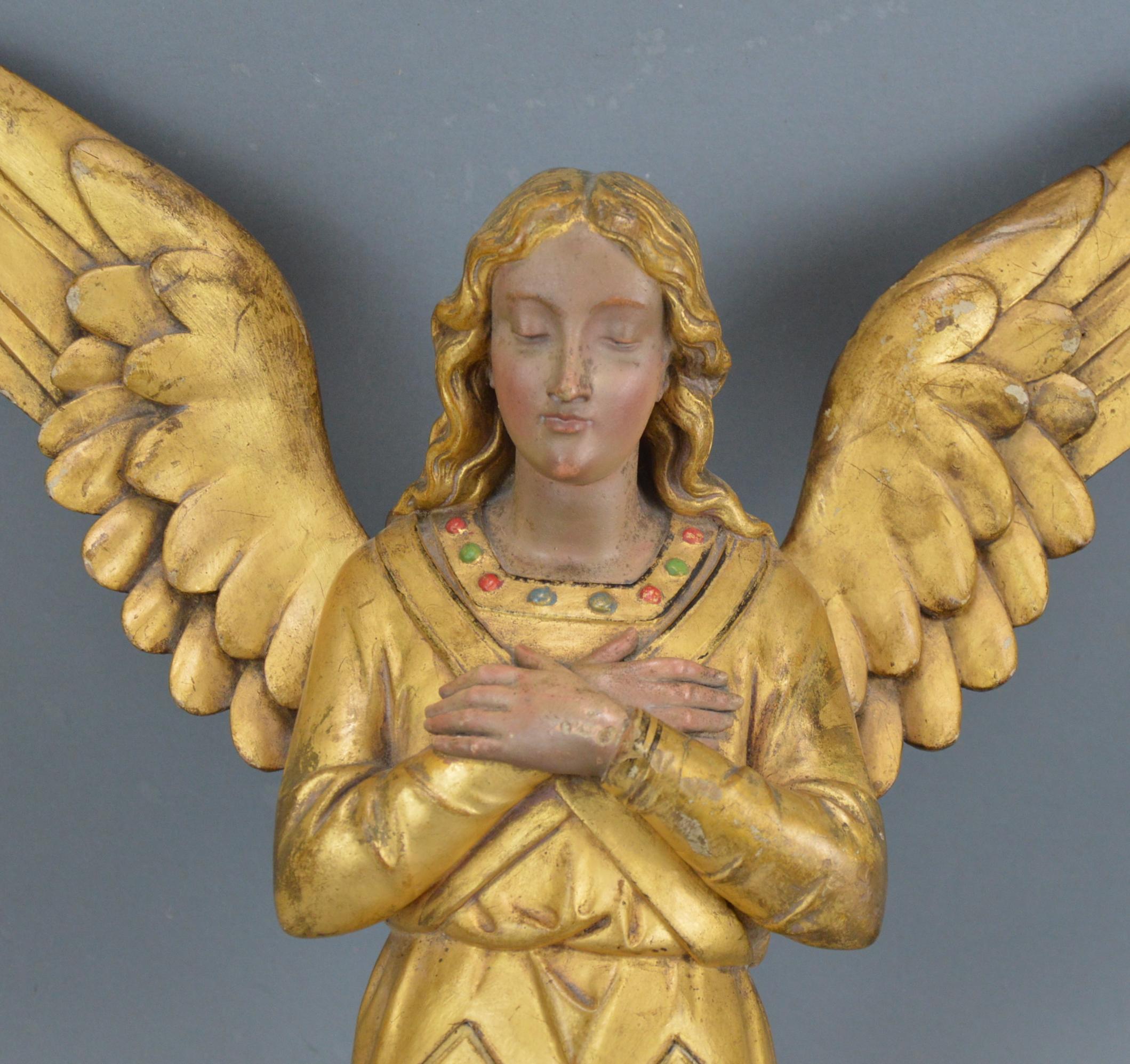 Gilt and painted carved wooden angel wall-sculpture, 19th century.