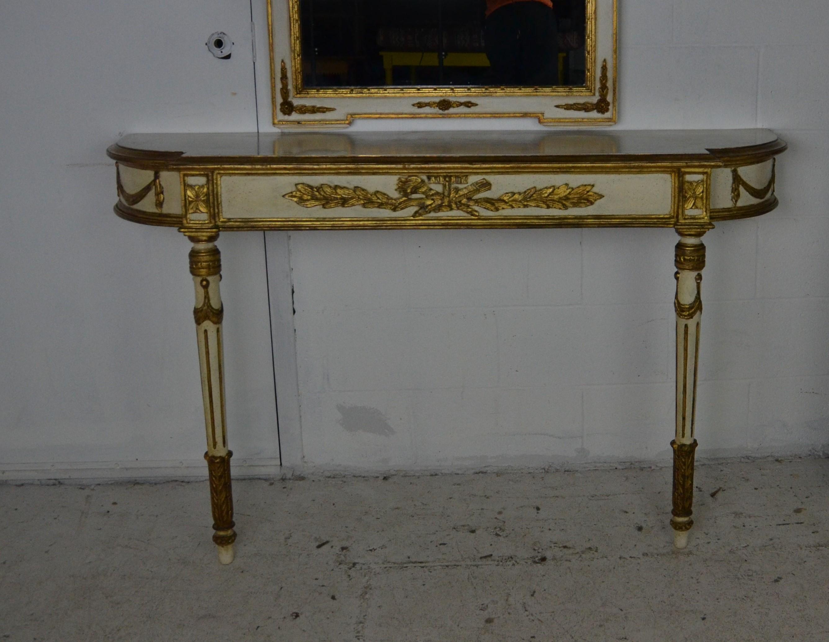 A console and mirror in the Louis XVI style. Original paint finish with gilt decorations.