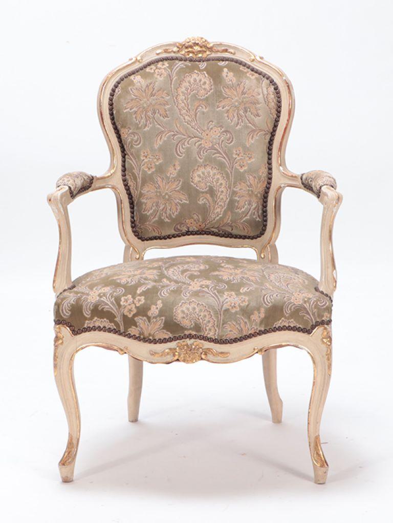 A gilt and painted French upholstered open armchair in the Louis XV style circa 1900.