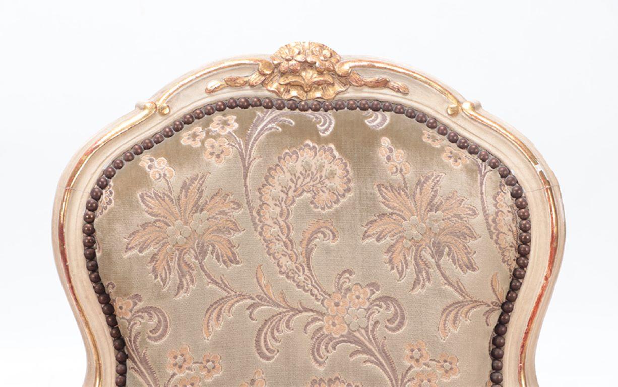 Gilt and painted French upholstered open armchair in the Louis XV style. In Good Condition For Sale In Philadelphia, PA