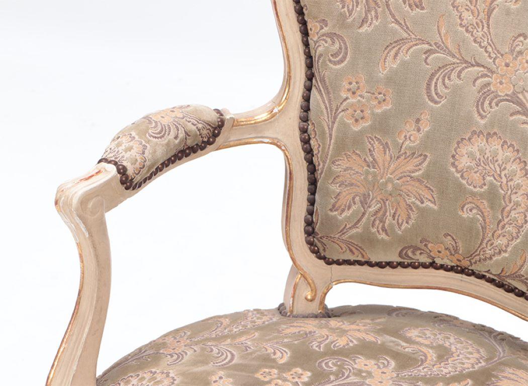 Early 20th Century Gilt and painted French upholstered open armchair in the Louis XV style. For Sale