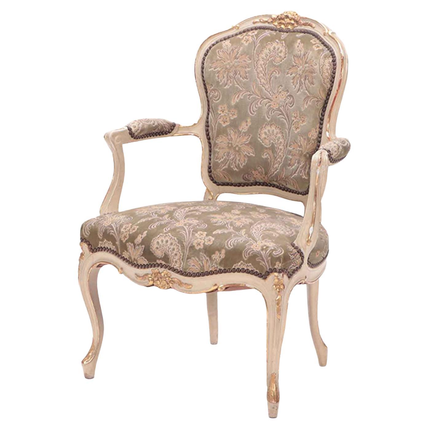 Gilt and painted French upholstered open armchair in the Louis XV style. For Sale