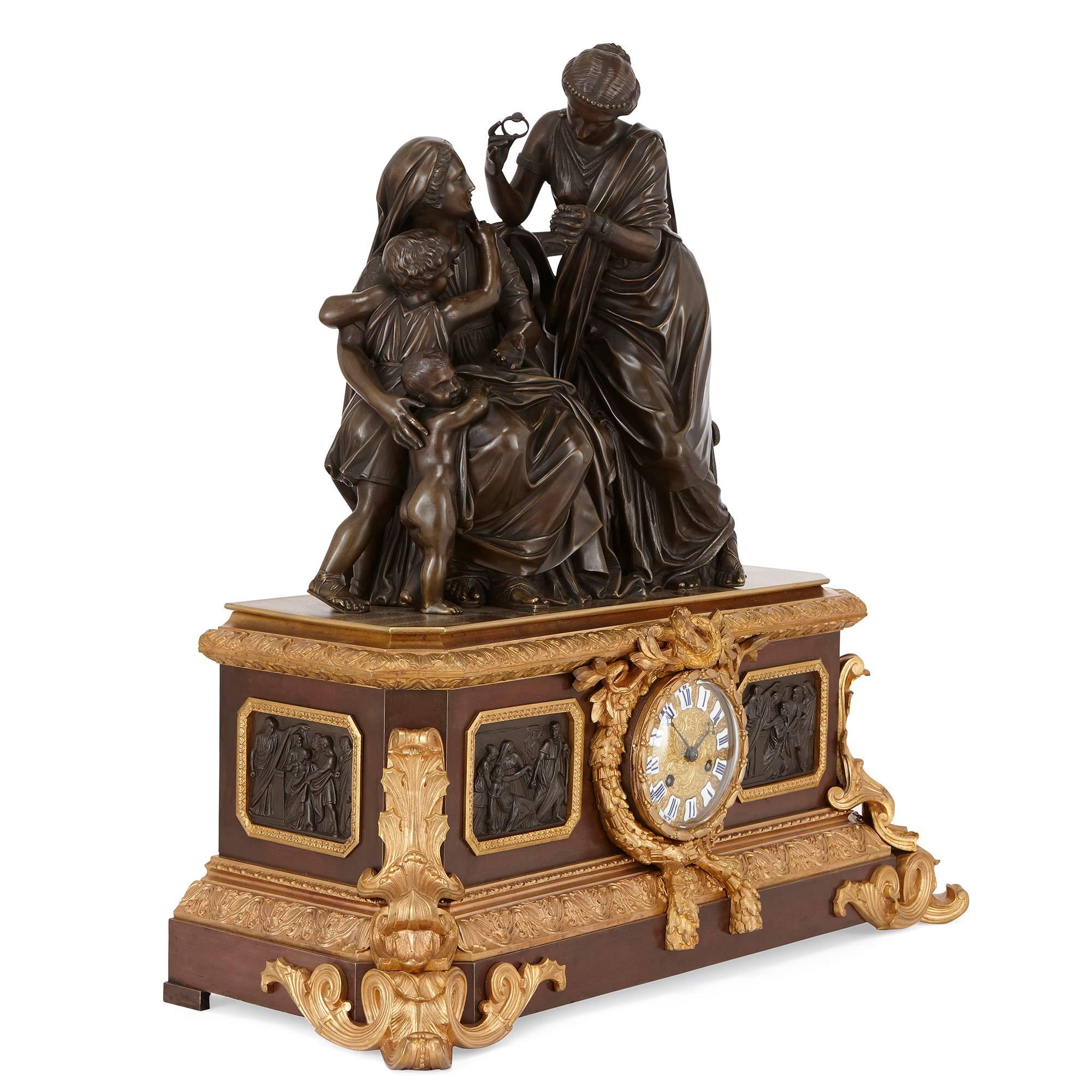 Comprising a central clock and a pair of flanking candelabra, the central circular dial surrounded by a laurel wreath and bow ormolu mount, with plaques depicting biblical scenes in relief on either side, surmounted by a large patinated bronze