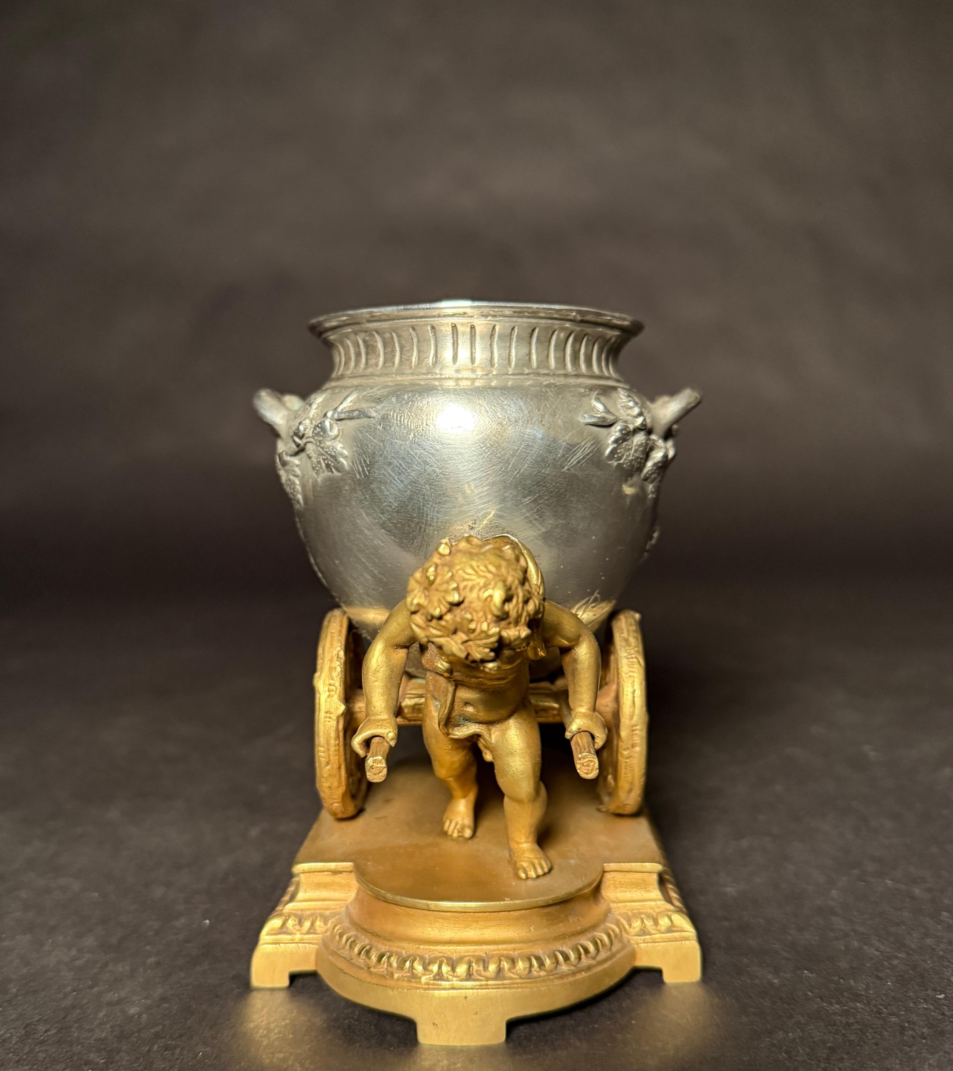 French Gilt And Silvered Bronze Table Ornament With Putti And Urn For Sale