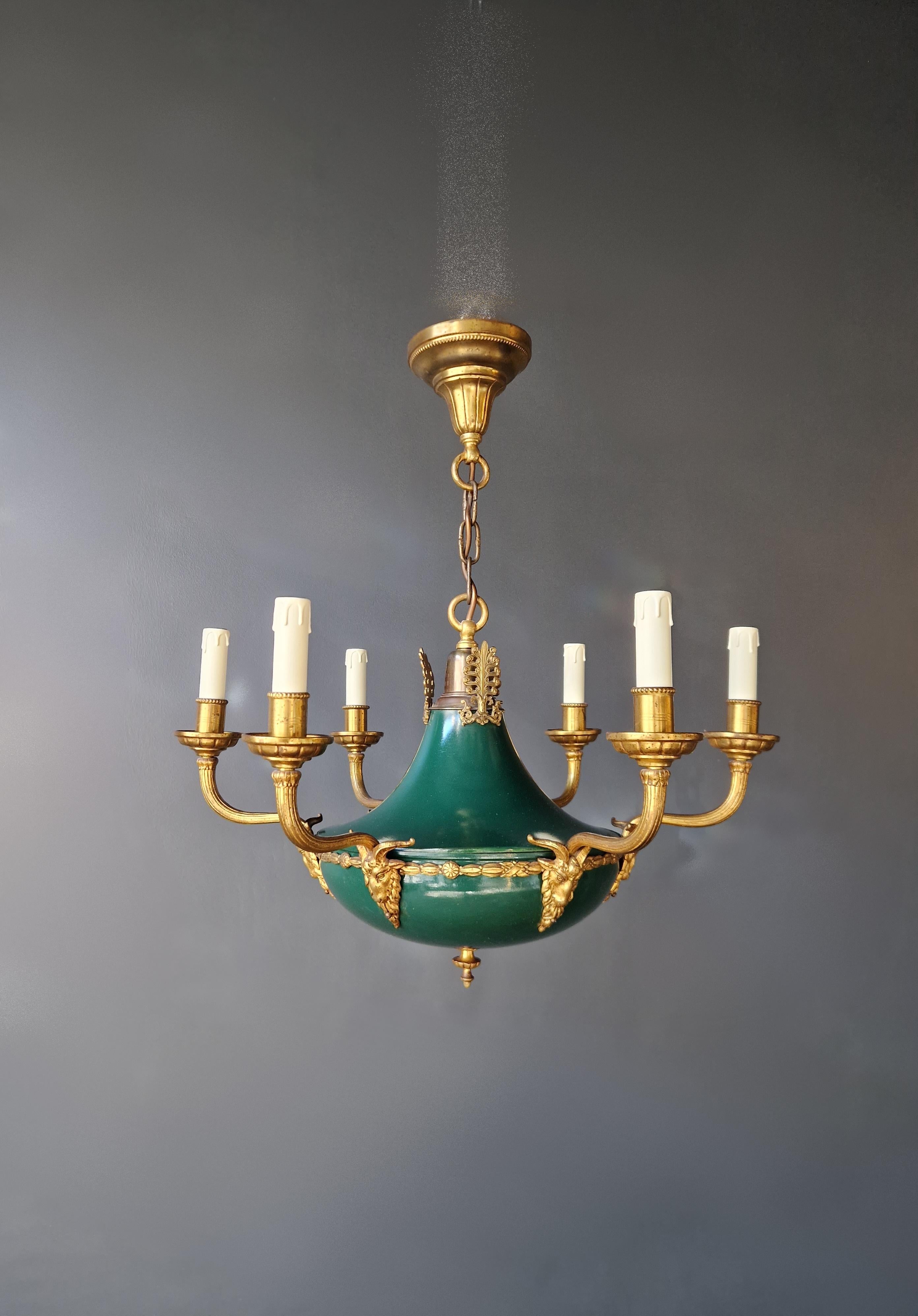 Introducing our exquisite Gilt Antique Empire Lustre Neoclassical Patina Green Brass Chandelier, a fine example of antique German Louis XVI style gilt bronze with patinated bronze.

This chandelier has undergone meticulous restoration, with cabling