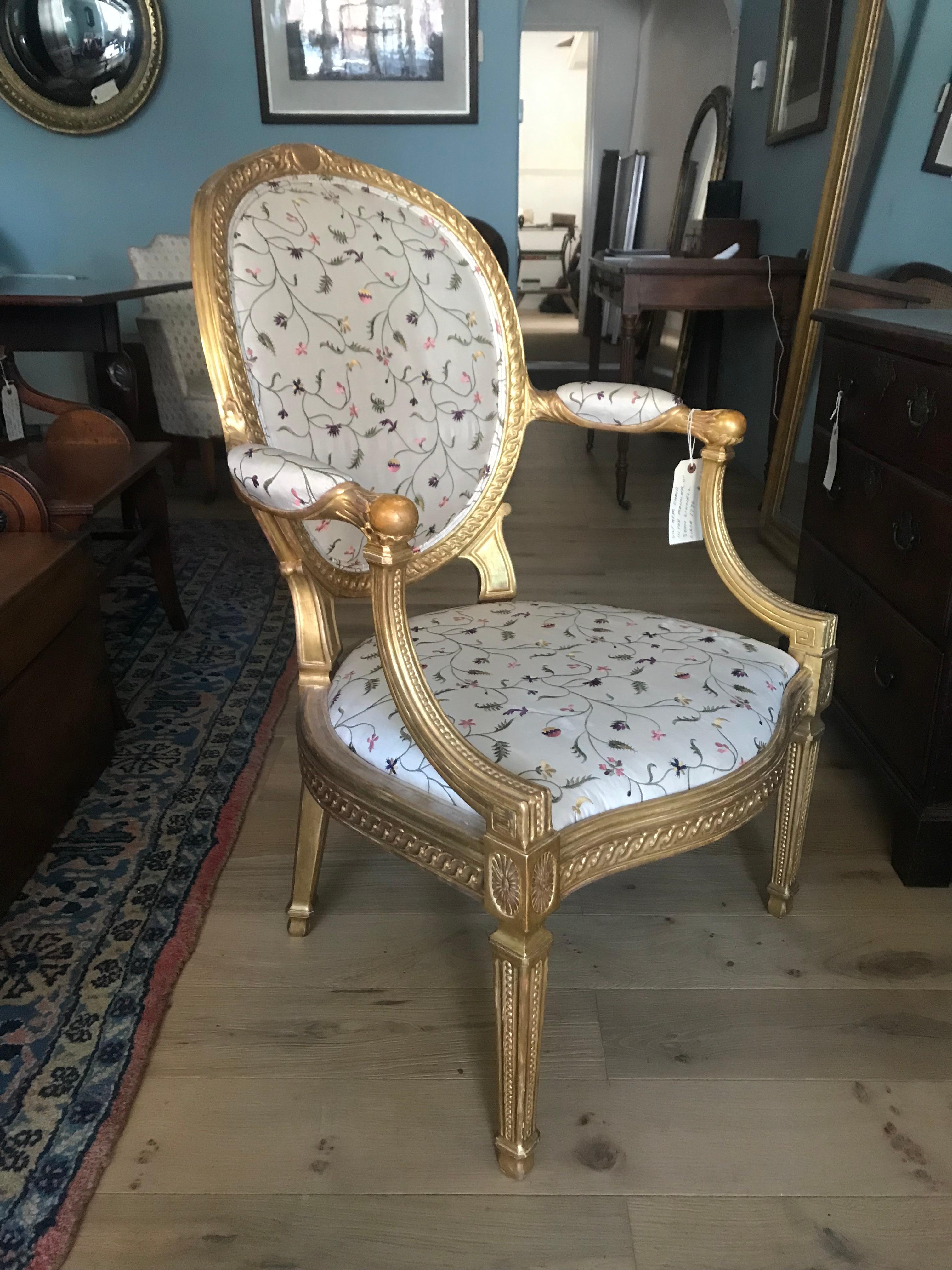 This stunning gilt armchair is in the manner of John Linnell, circa 1770.
The back is oval padded with attractive upholstery, framed with guilloche carving, the chair rails feature the same design. The arms are classic Linnell design, the ball