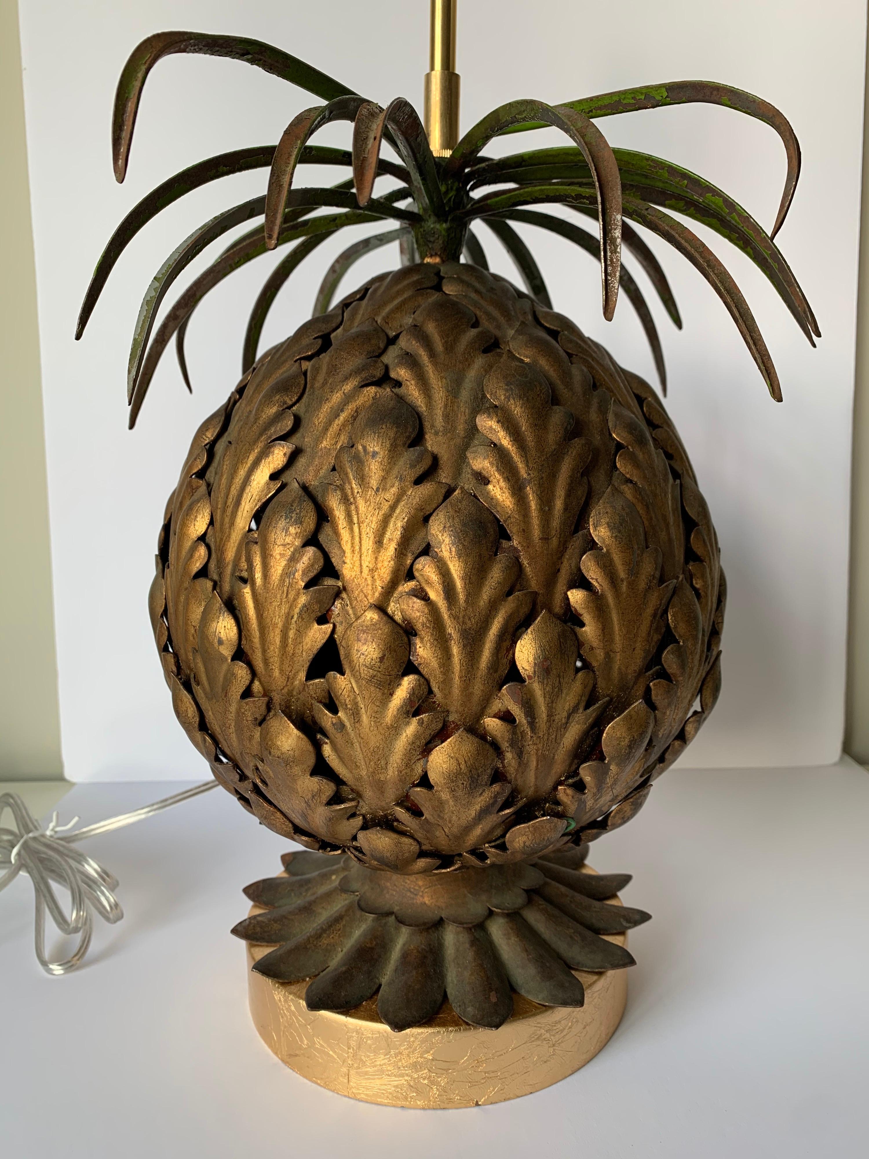 1950s Italian gilt metal pineapple motif lamp. Newly rewired with new gold painted wood base. Lamp takes one standard bulb (not included). Lamp has overall age related wear and overall paint loss, consistent with the antique finish. Lamp is 20” tall