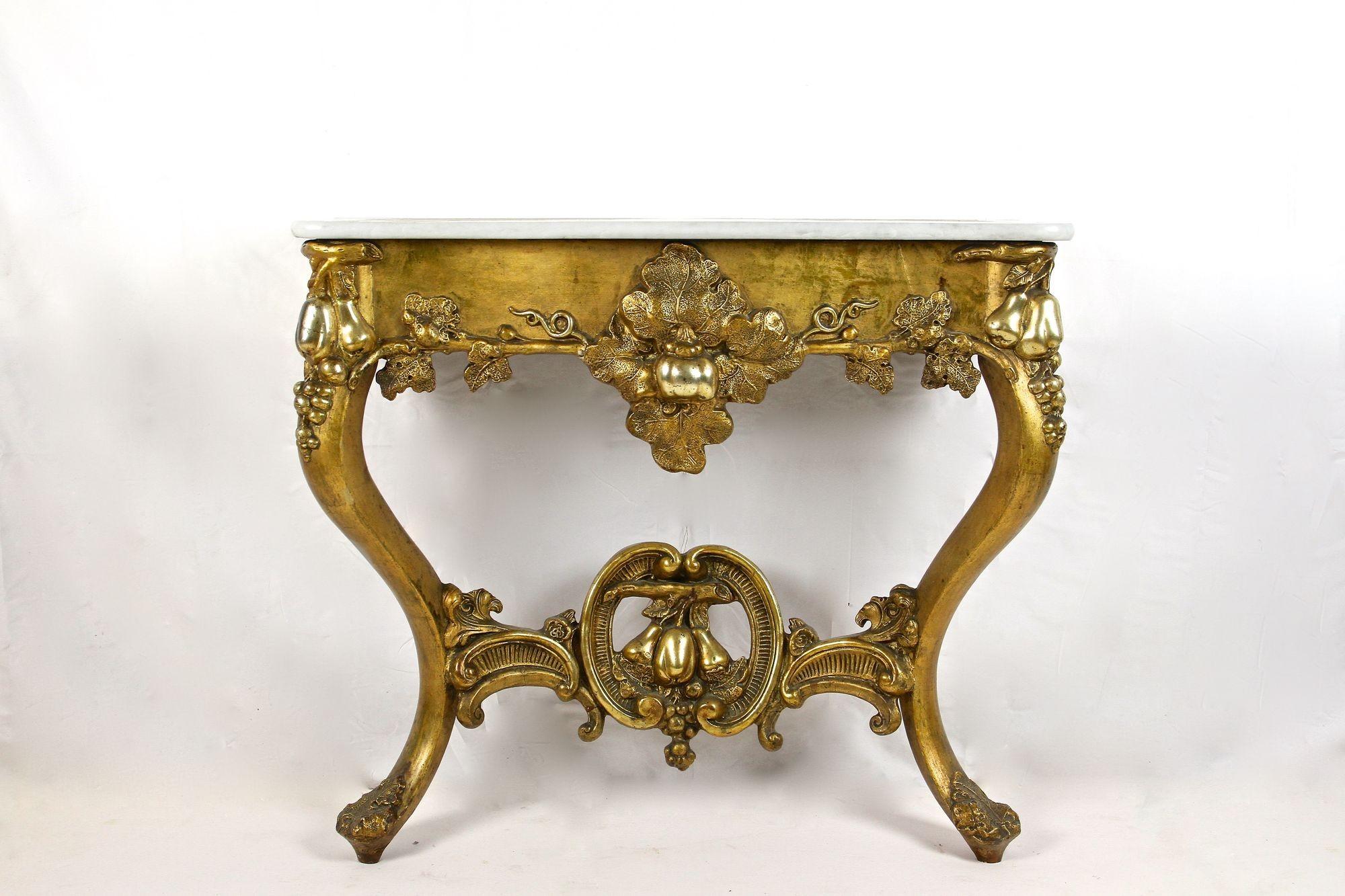 Noble 18th century gilt baroque wall console table out of Austria from the period around 1780. Showing a very artfully processed design, this amazing looking wall console was part of the inventory of a castle. Hand crafted in the late baroque era